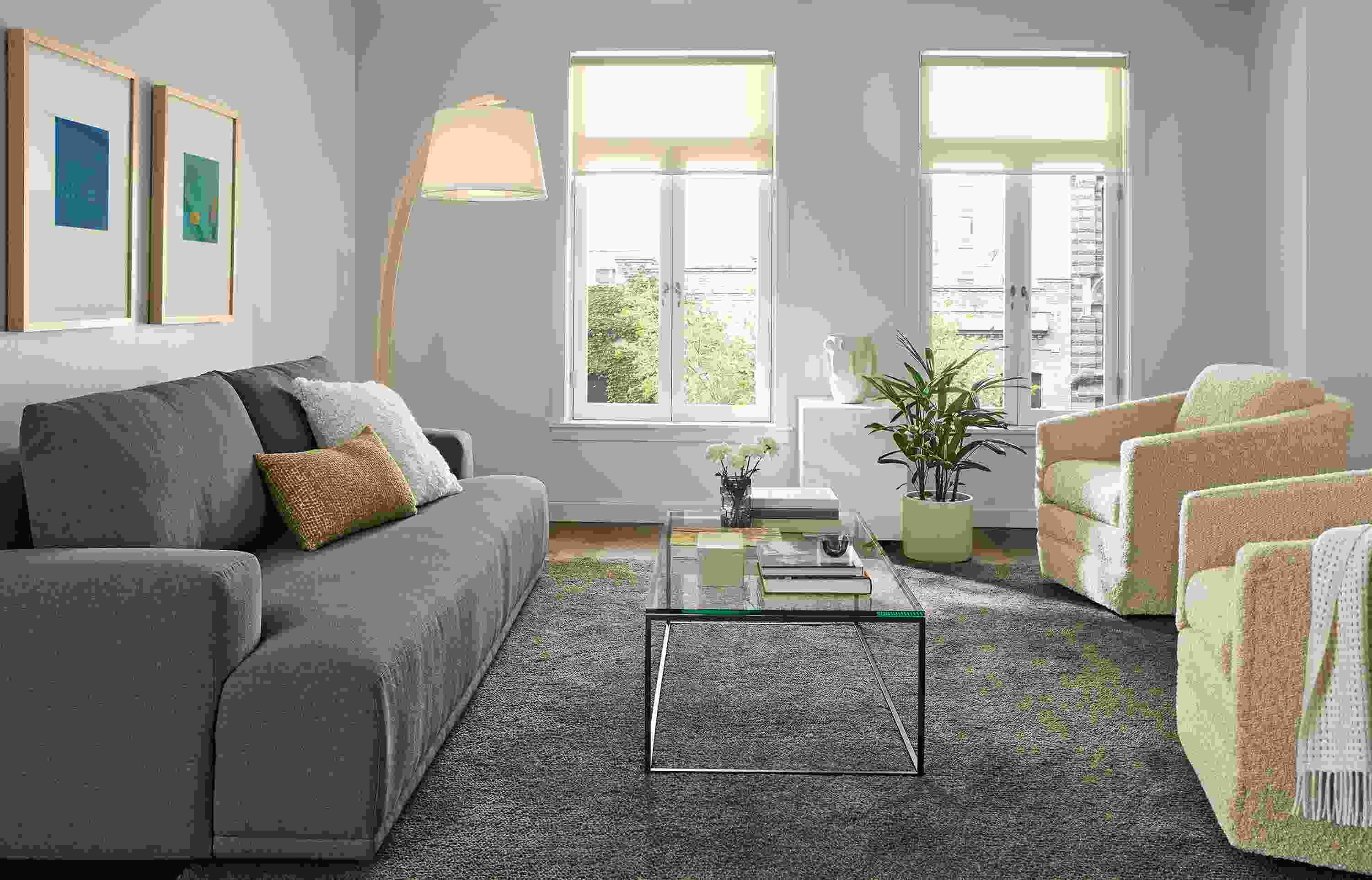 Living room with Fia 96-wide sofa in Myers Pine, 2 Ford swivel chairs in Dornick Ivory and Arden 8 by 10 rug in earth.