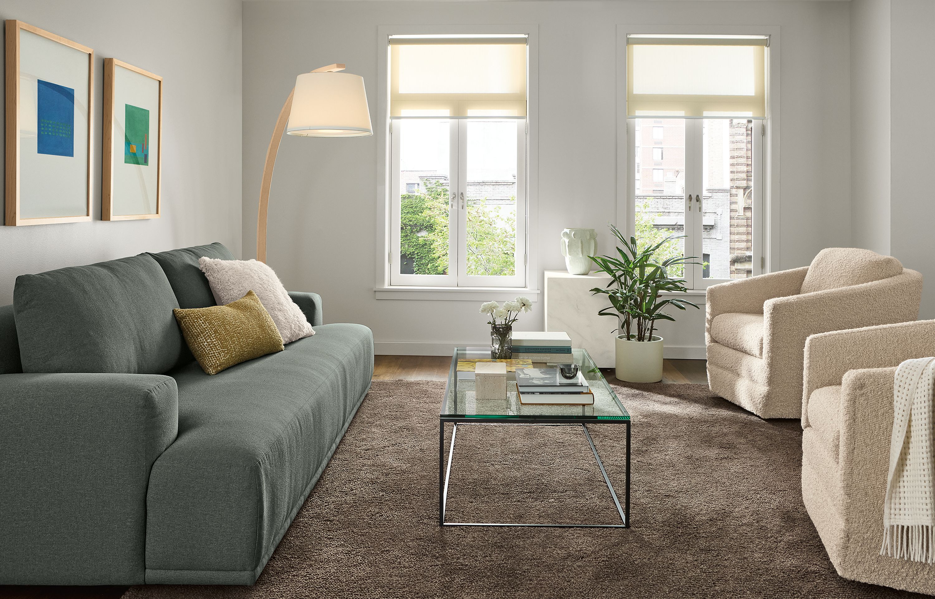 Living room with Fia 96-wide sofa in Myers Pine, 2 Ford swivel chairs in Dornick Ivory and Arden 8 by 10 rug in earth.