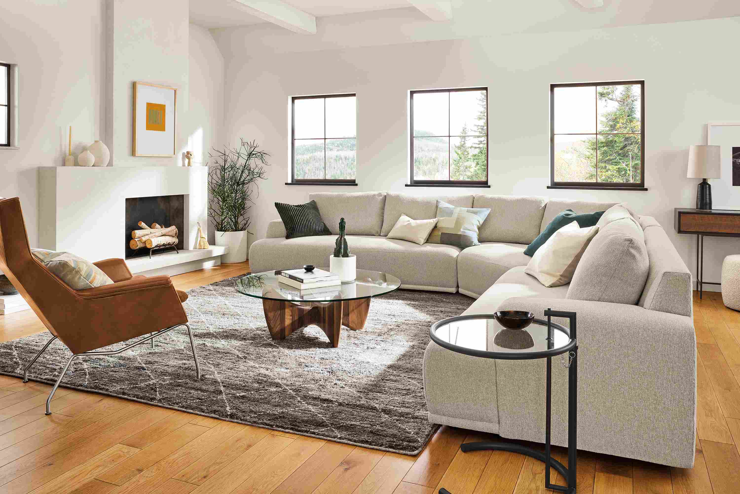 Living room with large Fia sectional, Aidan chair, Sanders coffee table, Kalindi rug.