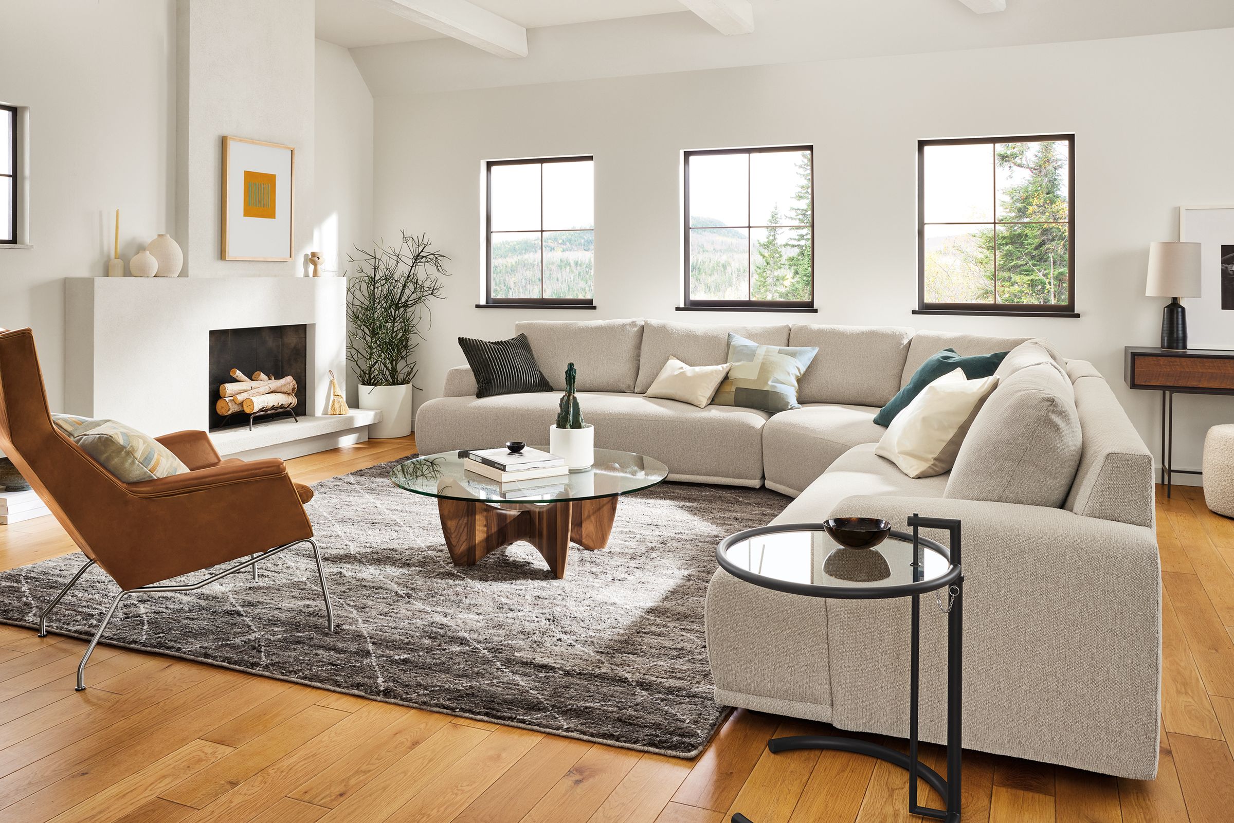 Living room with large Fia sectional, Aidan chair, Sanders coffee table, Kalindi rug.