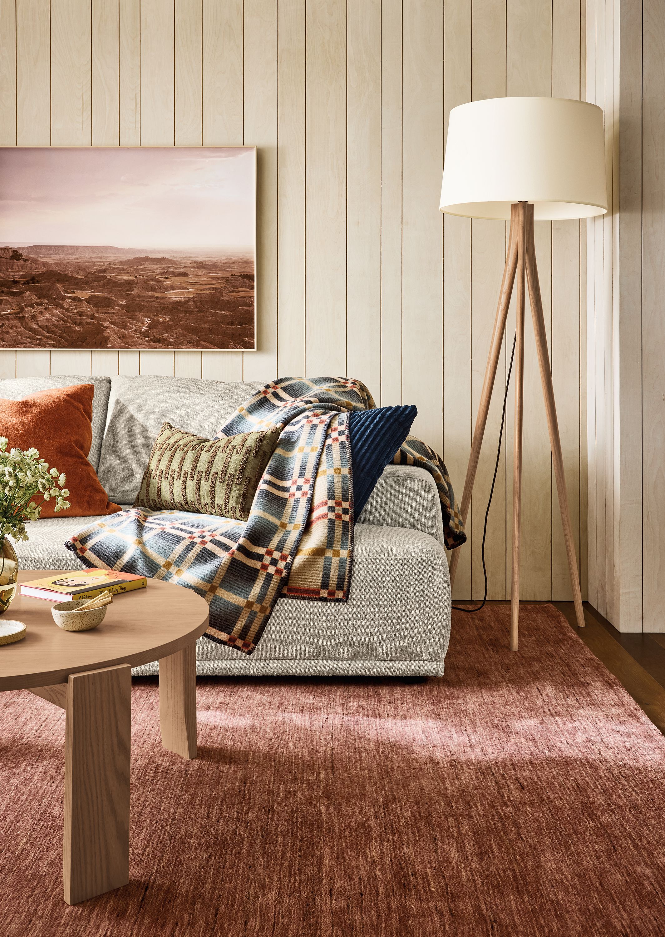 Living room with Fia Sofa in conley natural, Brandt round coffee table in rye on red oak and Nomad rug in brick.