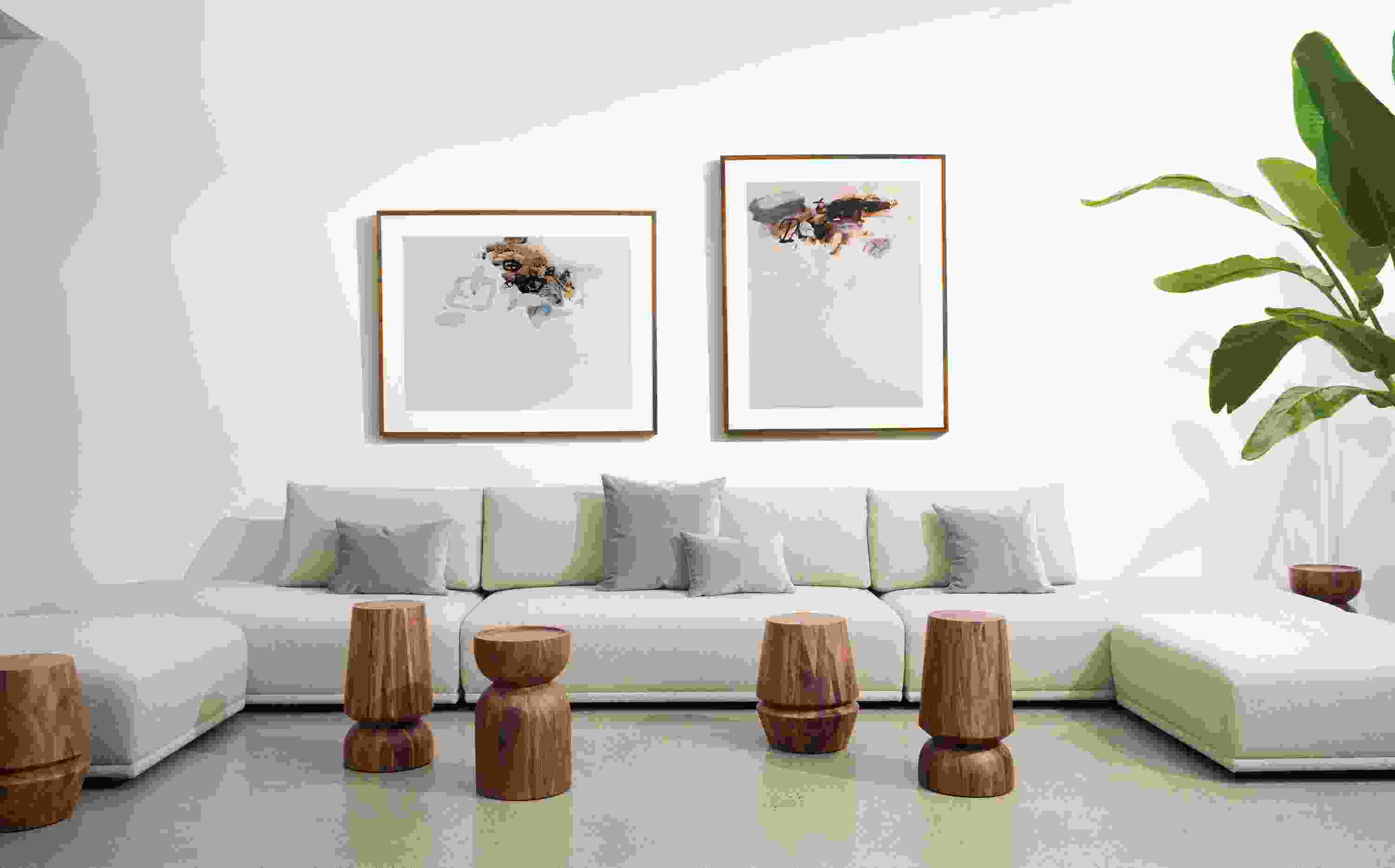 room setting including fia sectional in conley natural, nyla stools, gabriel belgeonne artwork.