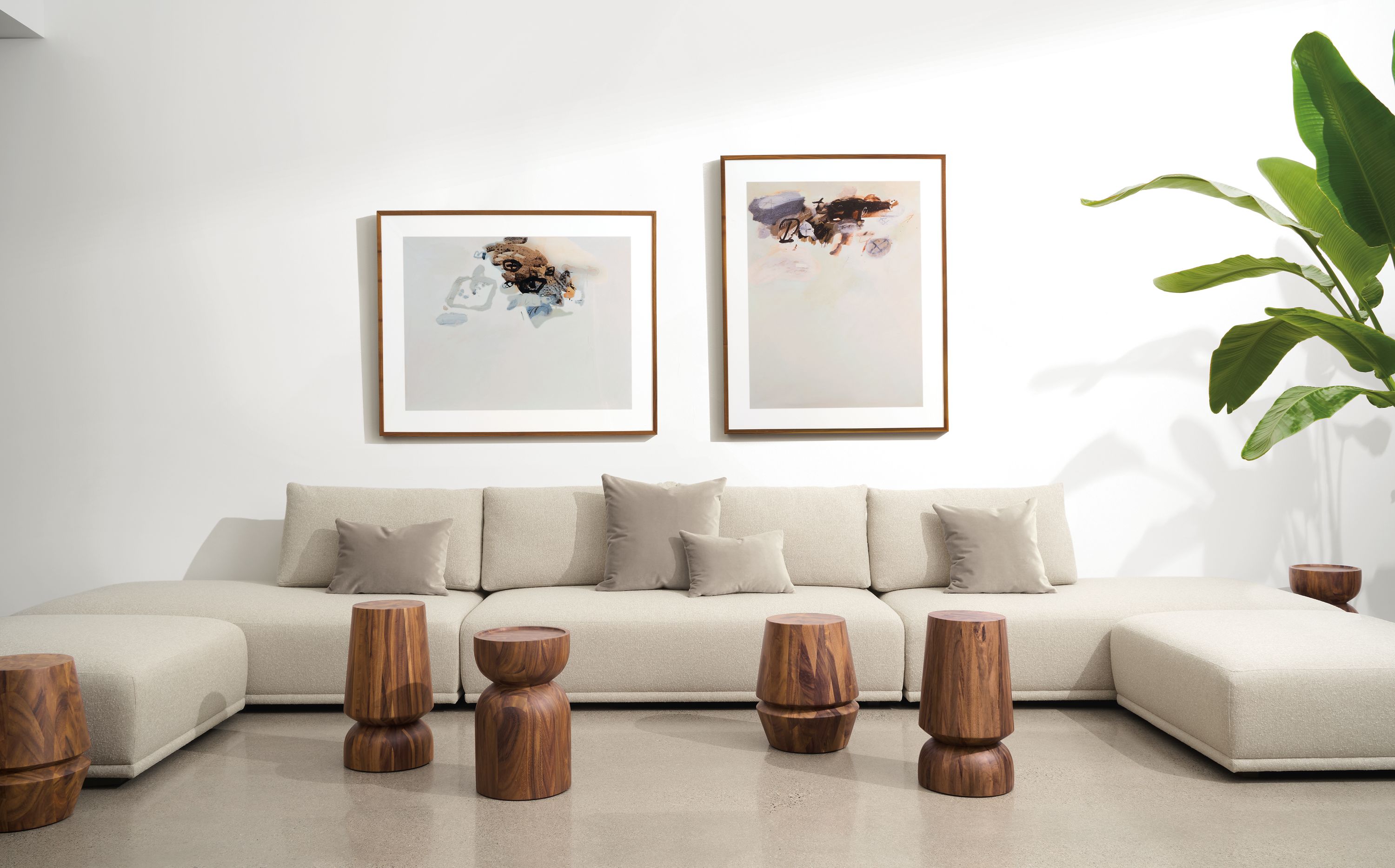 room setting including fia sectional in conley natural, nyla stools, gabriel belgeonne artwork.