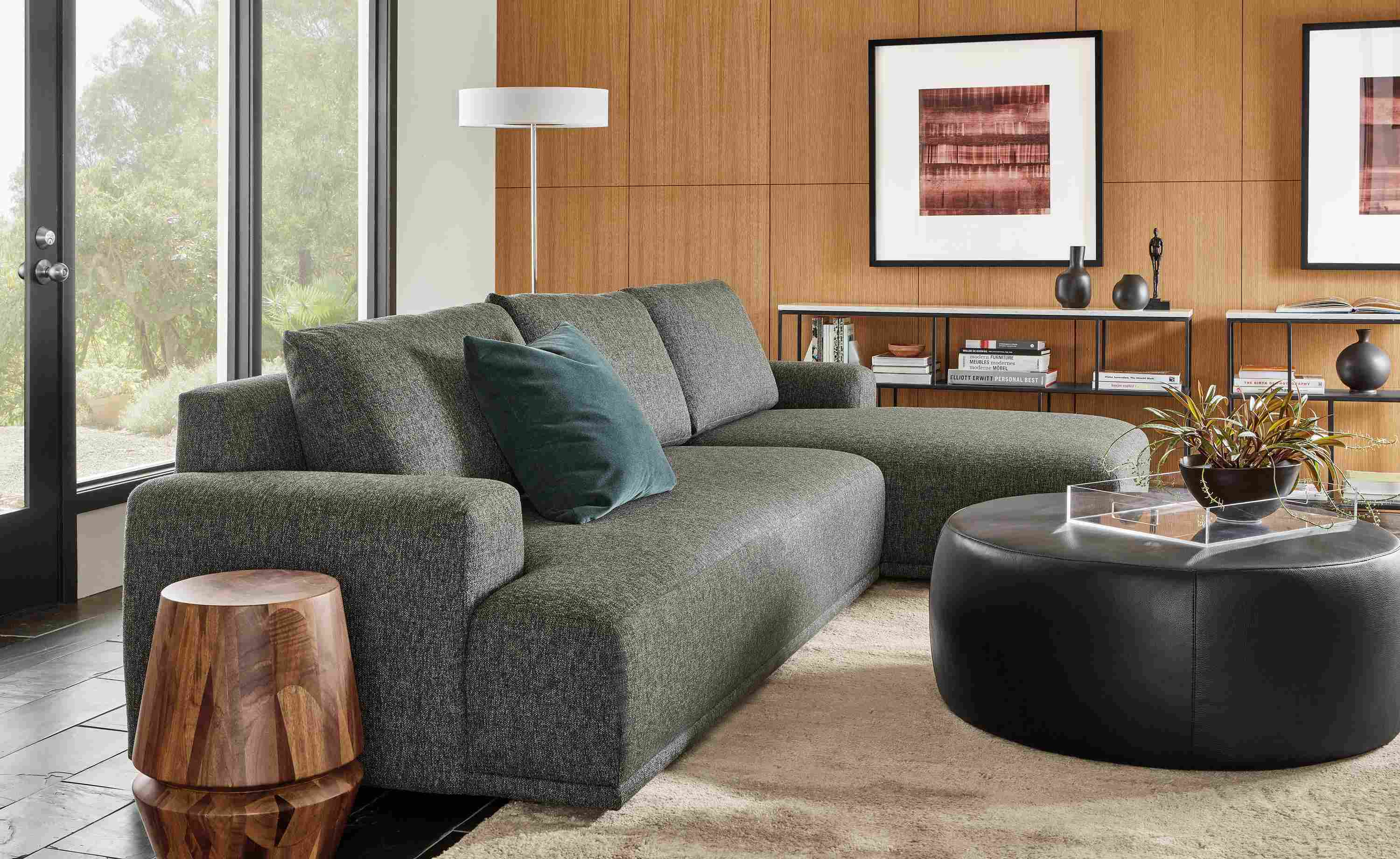 room setting with fia sofa, lind ottoman, karen revis wall art.
