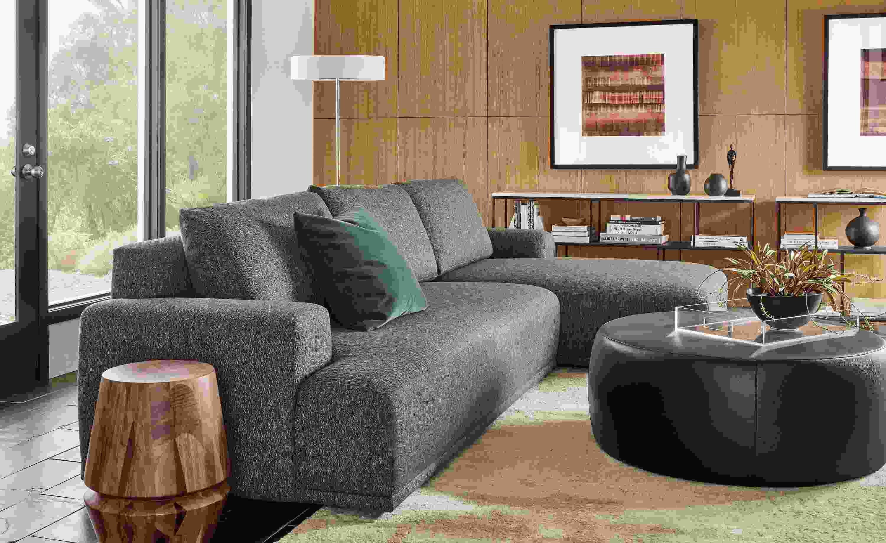 room setting with fia sofa, lind ottoman, karen revis wall art.