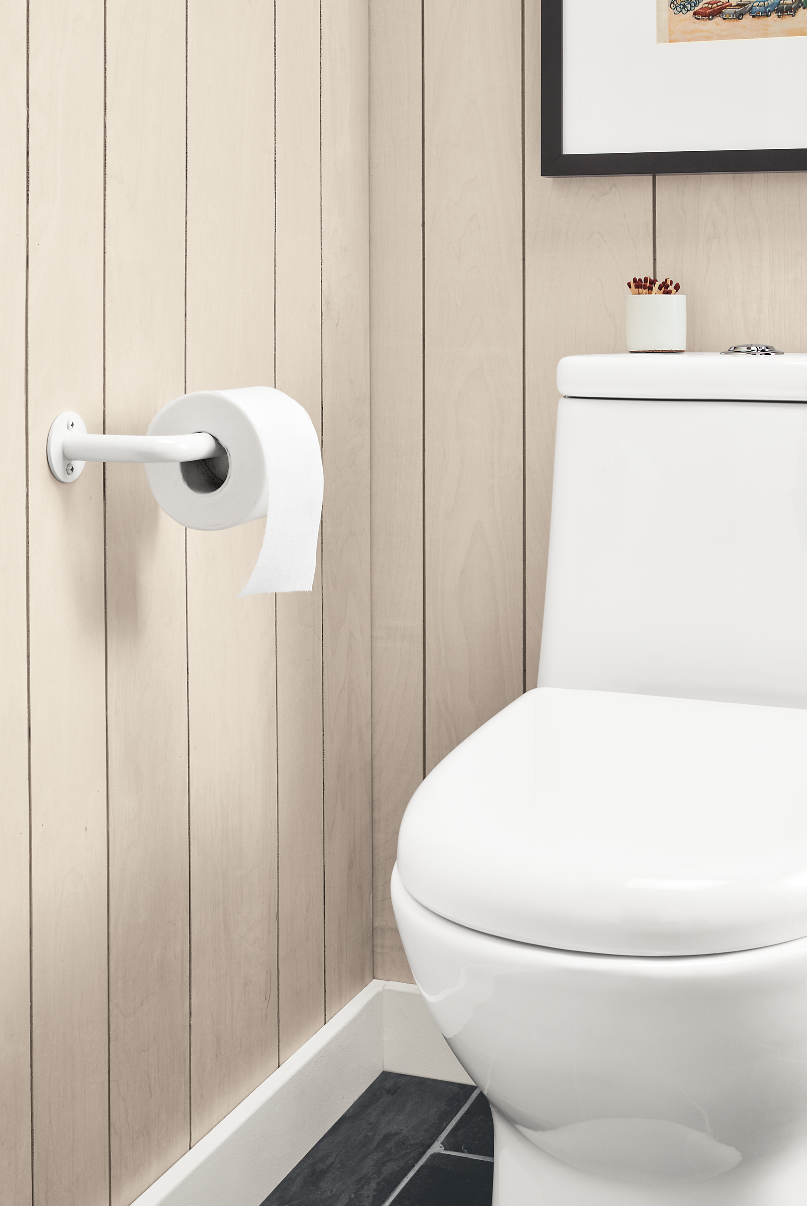 Detail of Filmore wall-mounted toilet paper holder in white.