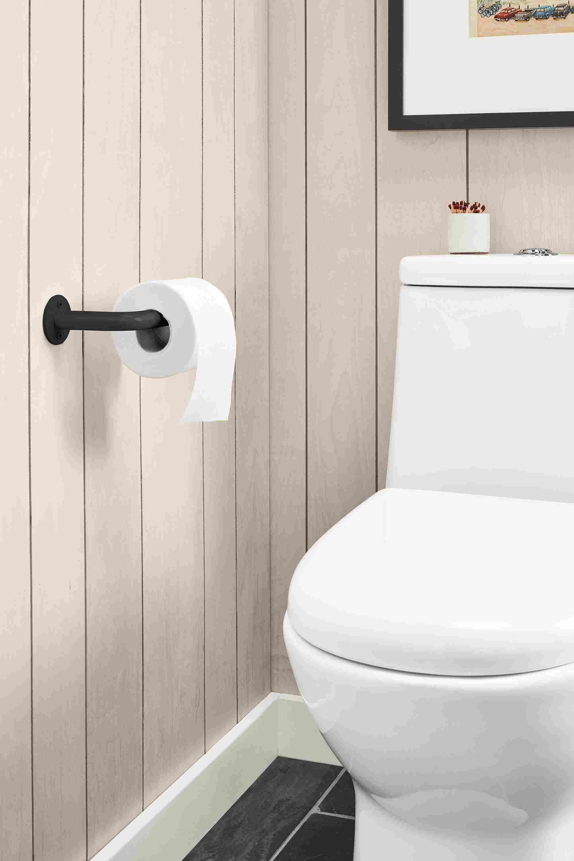Bathroom with detail of Filmore wall-mounted toilet paper holder in Onxy Gloss and Saco votive candle holder in white.