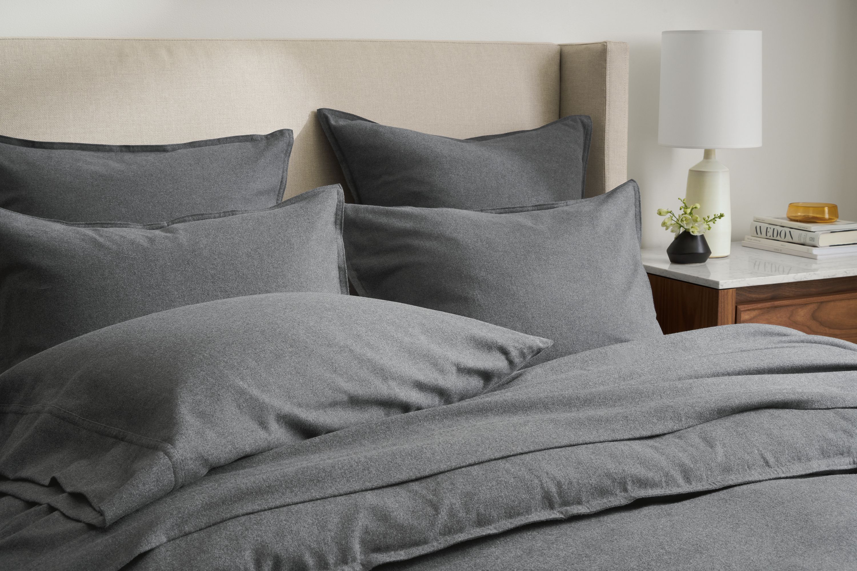 detail of heathered flannel sheets, duvet, shams on bed.