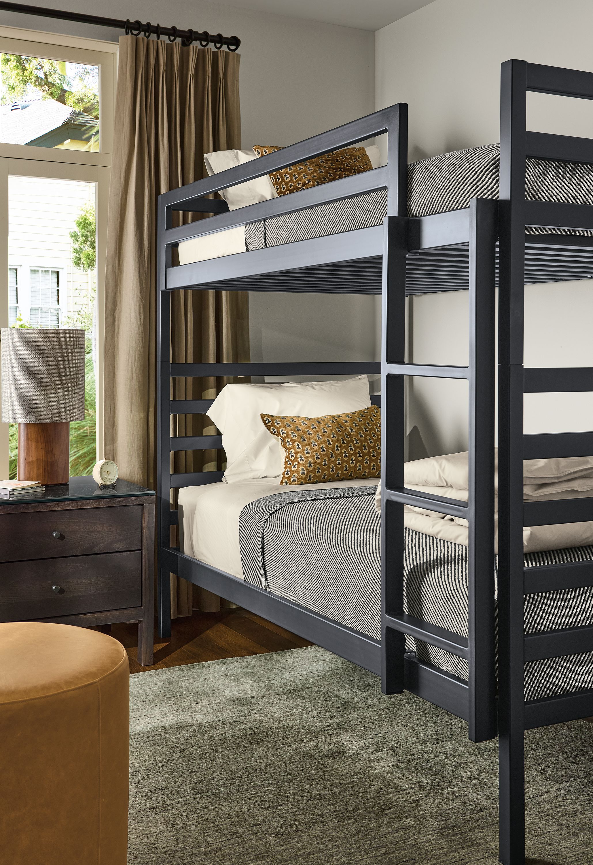Bedroom with Fort bunk bed in natural steel, emerson nightstand in charcoal on ash and Nomad rug in olive.
