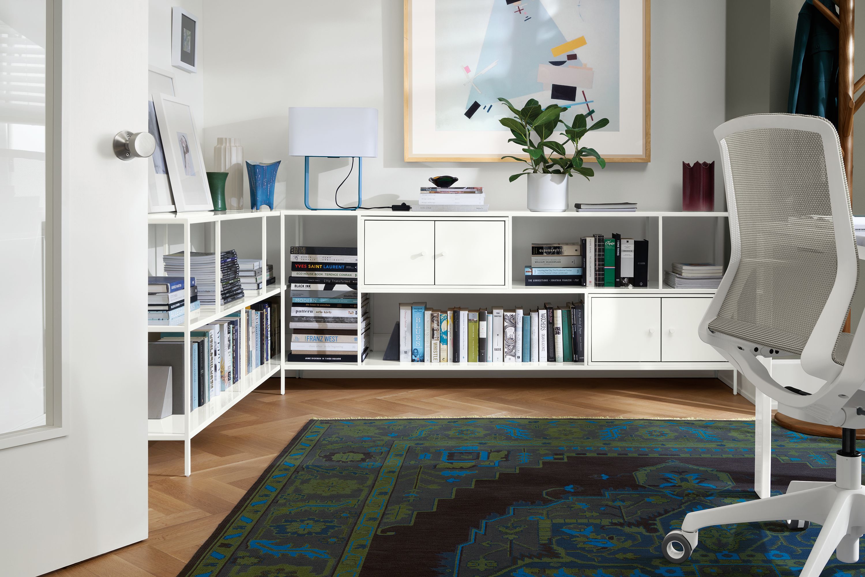 office with foshay console bookcases in white with white inserts, heriz rug, cynara office chair.