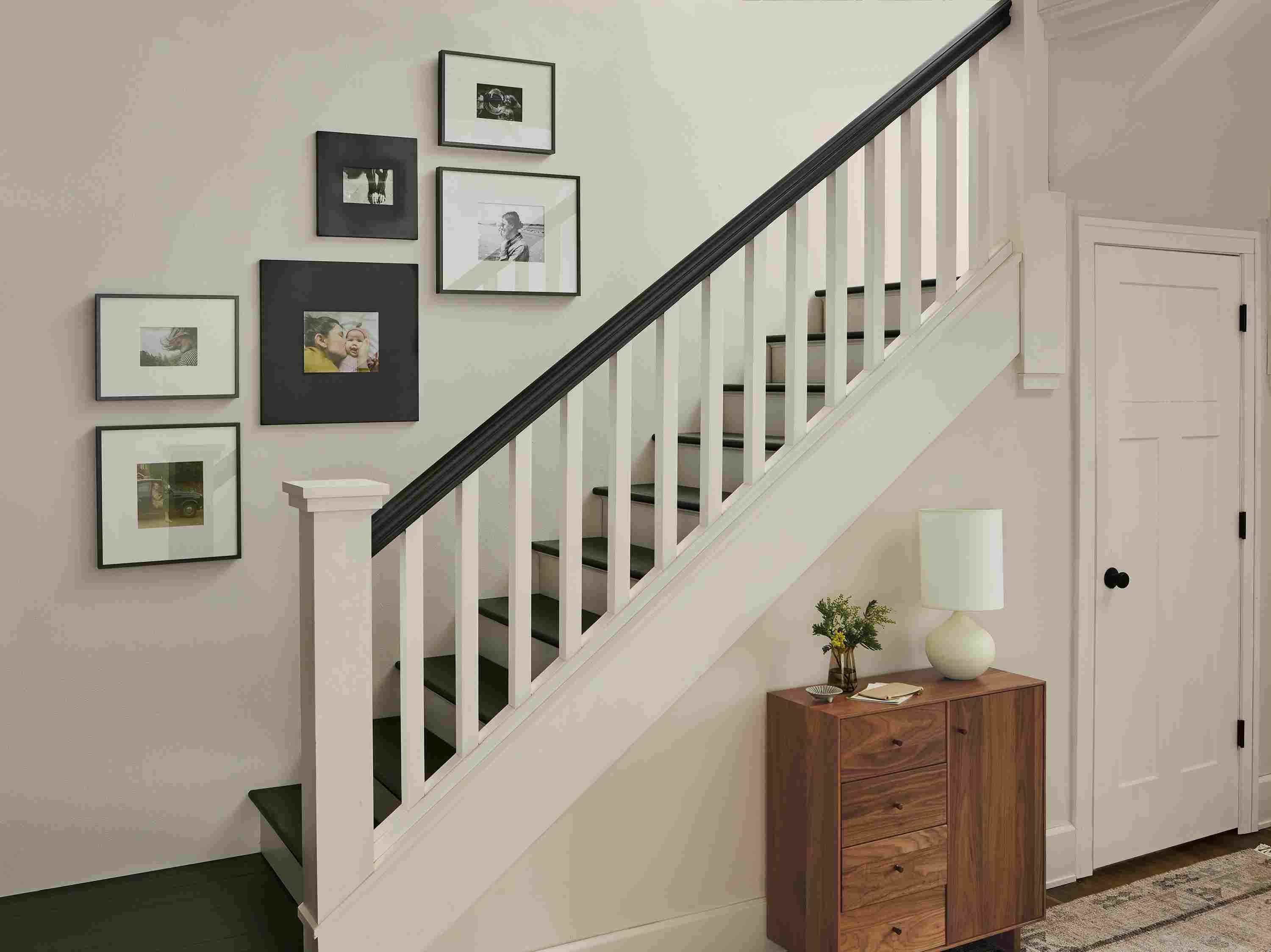 Stairway with a group of 6 Profile and Manhattan metal frames hung using arrangement from left stairway template.