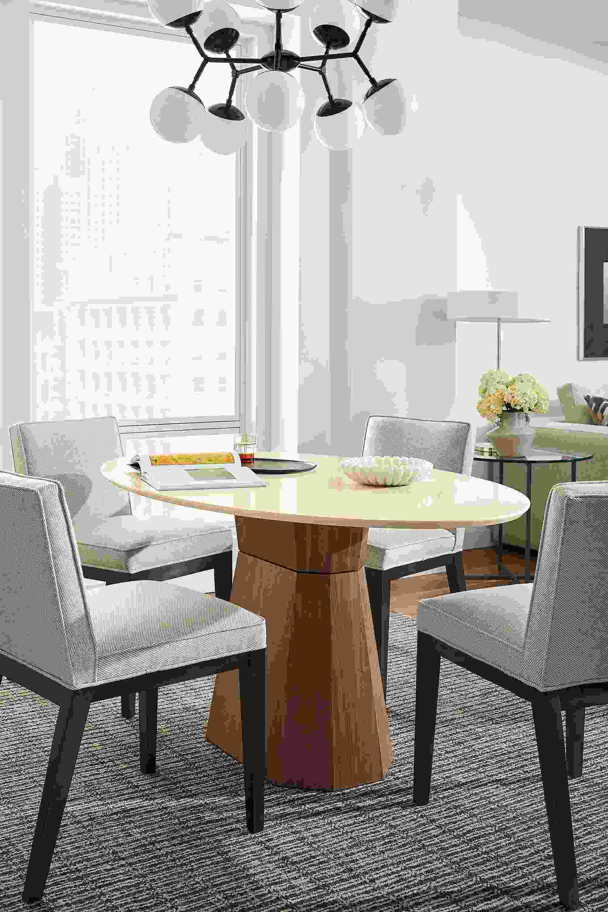 Dining room with Glover oval table in walnut and ecru quartz and 4 Ansel chairs in Derry Natural and charcoal.