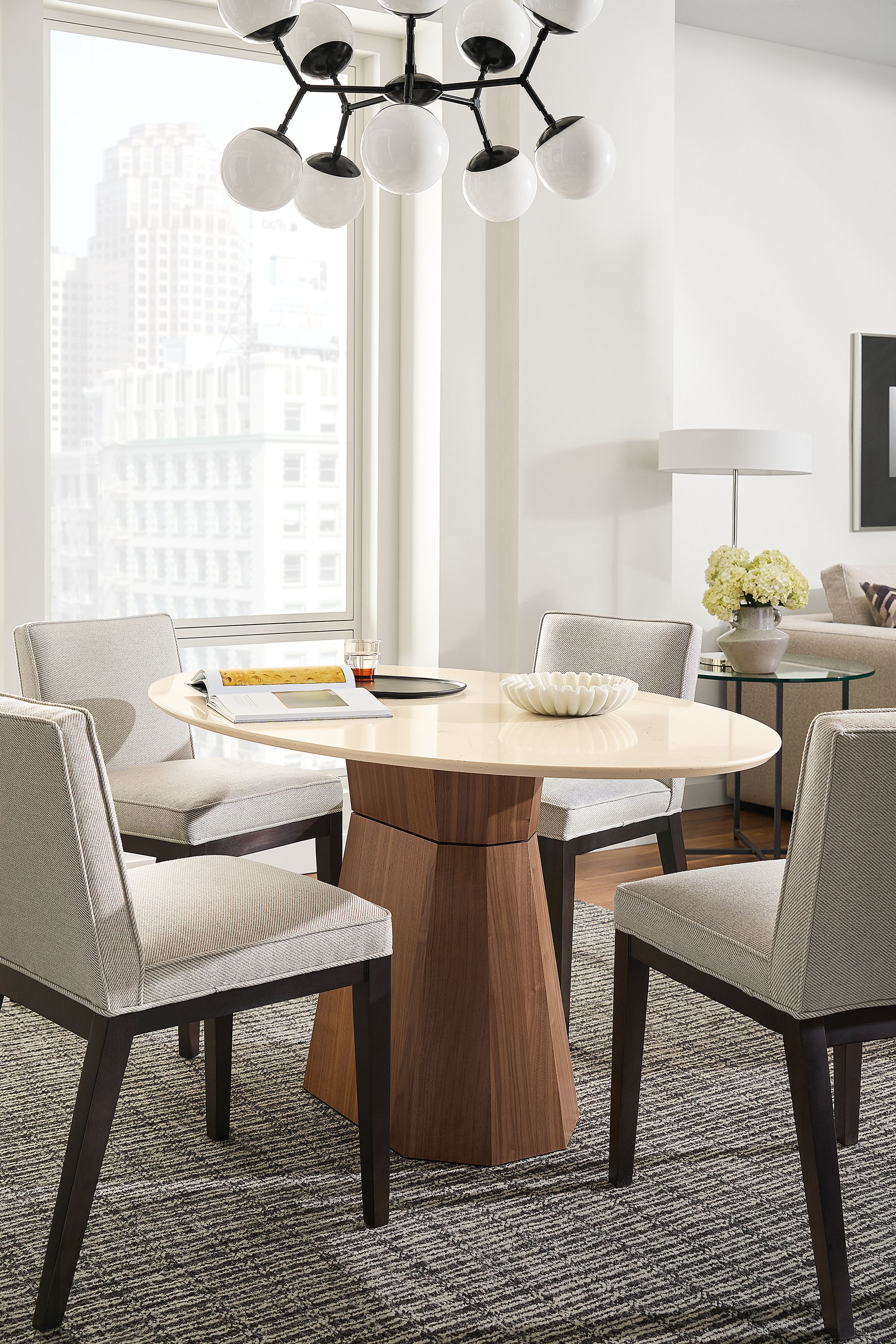 Dining room with Glover oval table in walnut and ecru quartz and 4 Ansel chairs in Derry Natural and charcoal.