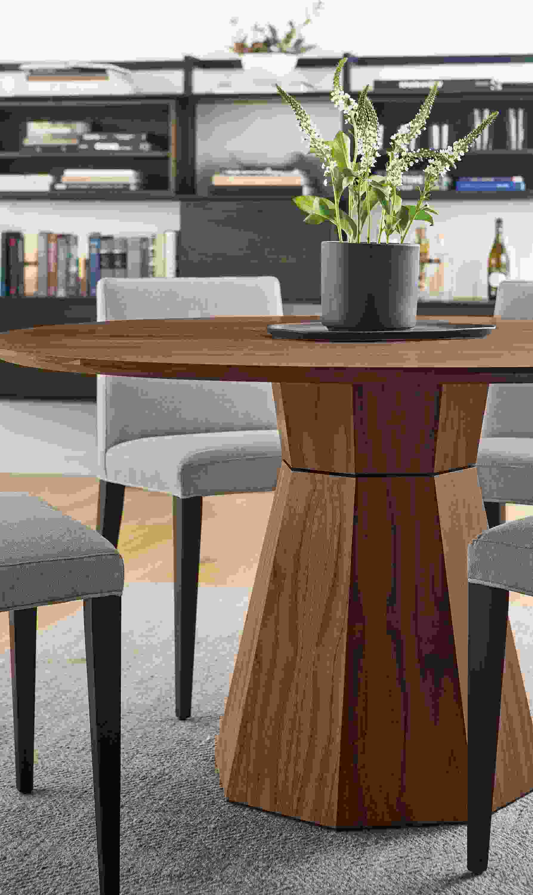 Dining space with Glover round dining table in walnut, 4 Ava side chairs in Flint Cement and Avilia rug in foxhound.