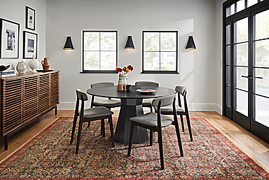 Dining room with Glover 54-diameter table in charcoal with Errol chairs in charcoal, and Helena 8 by 10 rug in Slate.