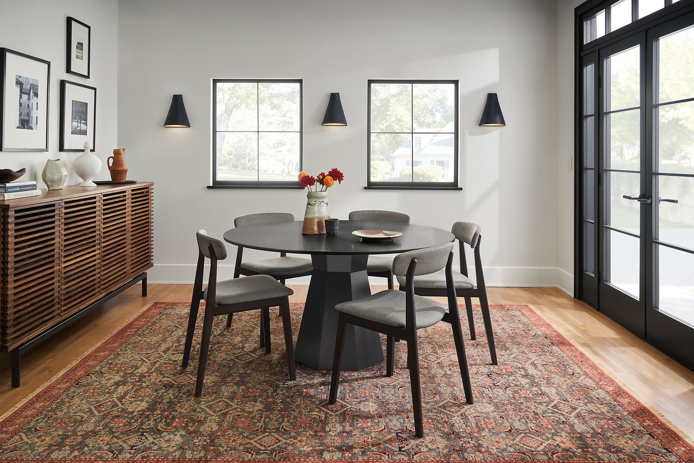 Dining room with Glover 54-diameter table in charcoal with Errol chairs in charcoal, and Helena 8 by 10 rug in Slate.
