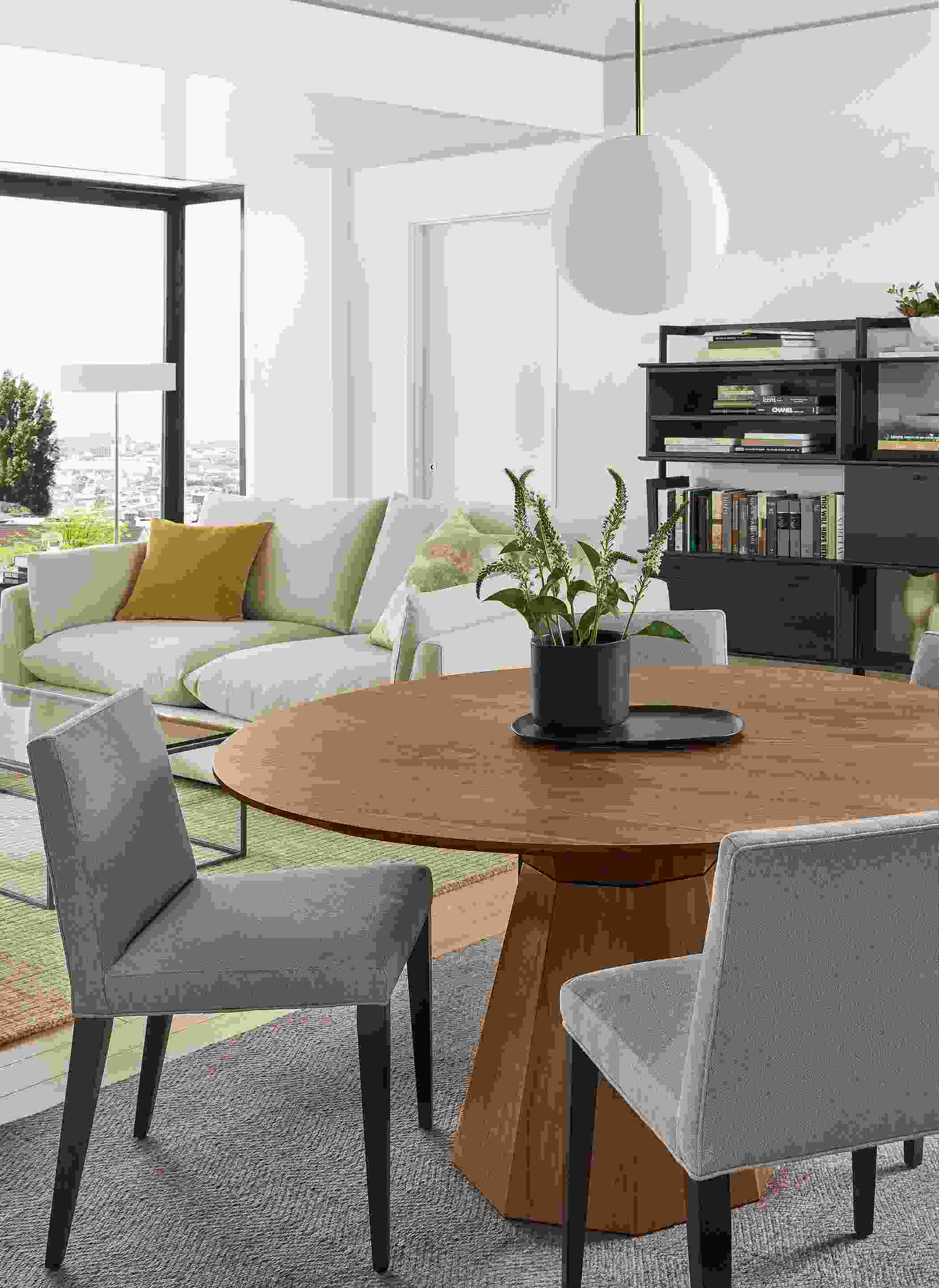 Dining space with Glover dining table in walnut, Ava chairs in Flint Cement and Orbit pendant.