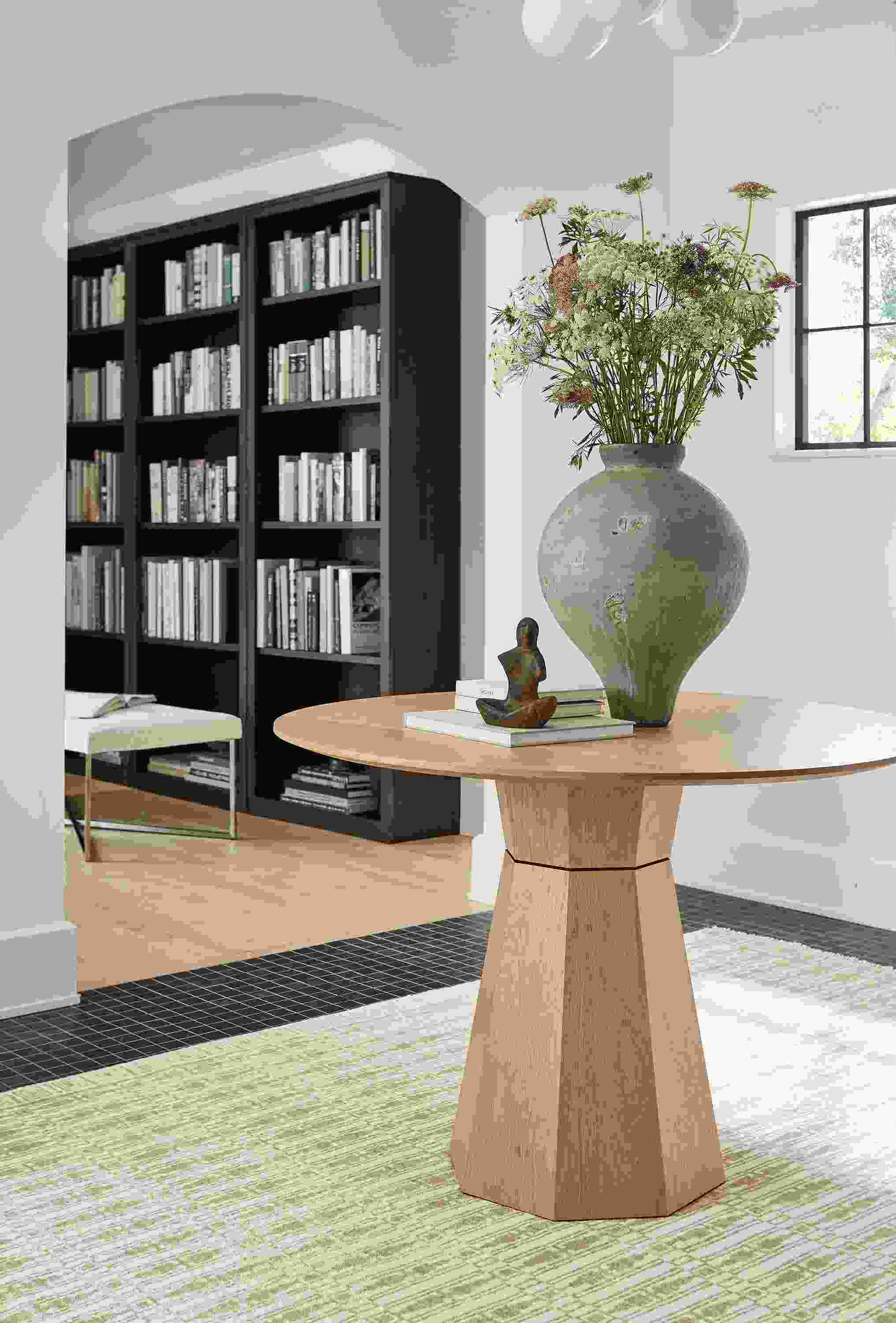 Entryway with Glover 42-diameter round table in rye on red oak and Tulum 6 by 9 rug Taupe.
