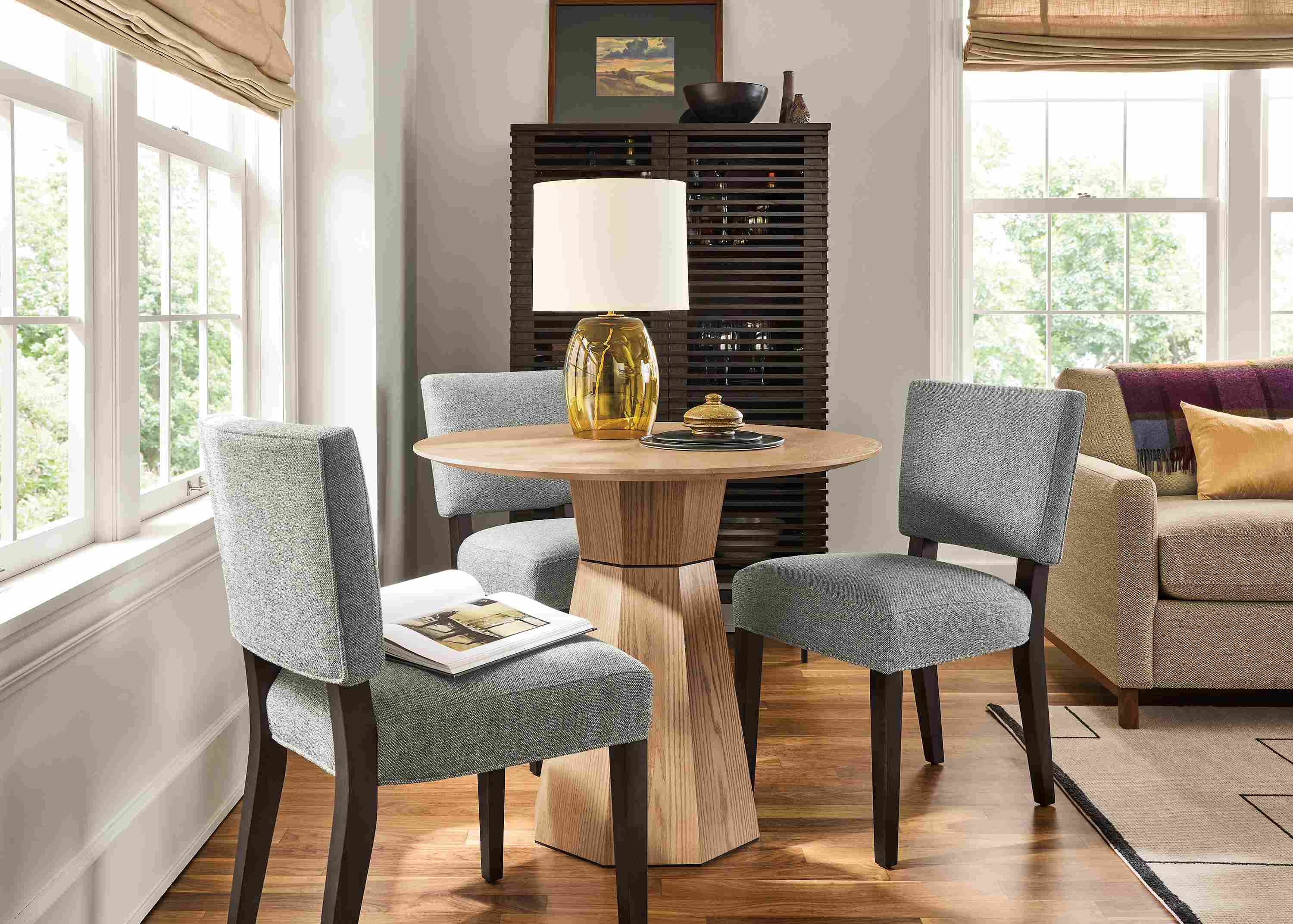 Great room with glover 36-diameter table in rye on red oak, 3 Georgia side chairs in Tatum Slate and Navi rug in ivory/black.