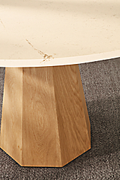 Detail of Glover 48 diameter round table in white oak with ecru quartz top and Avilia 8 by 10 rug in foxhound.