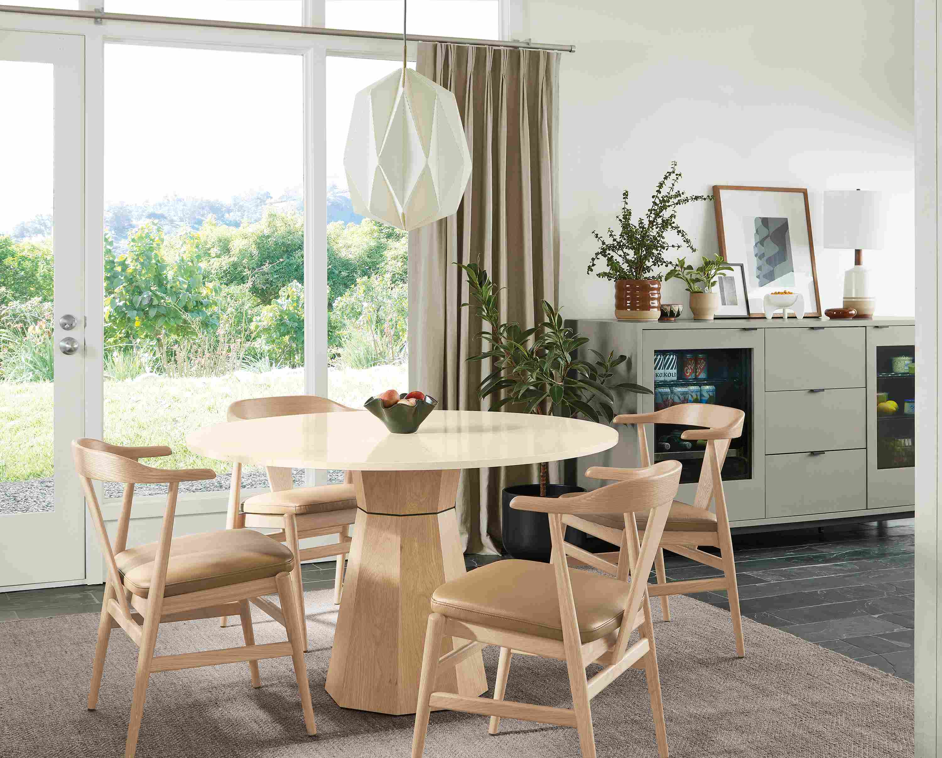 Dining room with a Glover 48 diameter round table in white oak, evan arm chairs in white oak with Pesaro Camel leather seats.