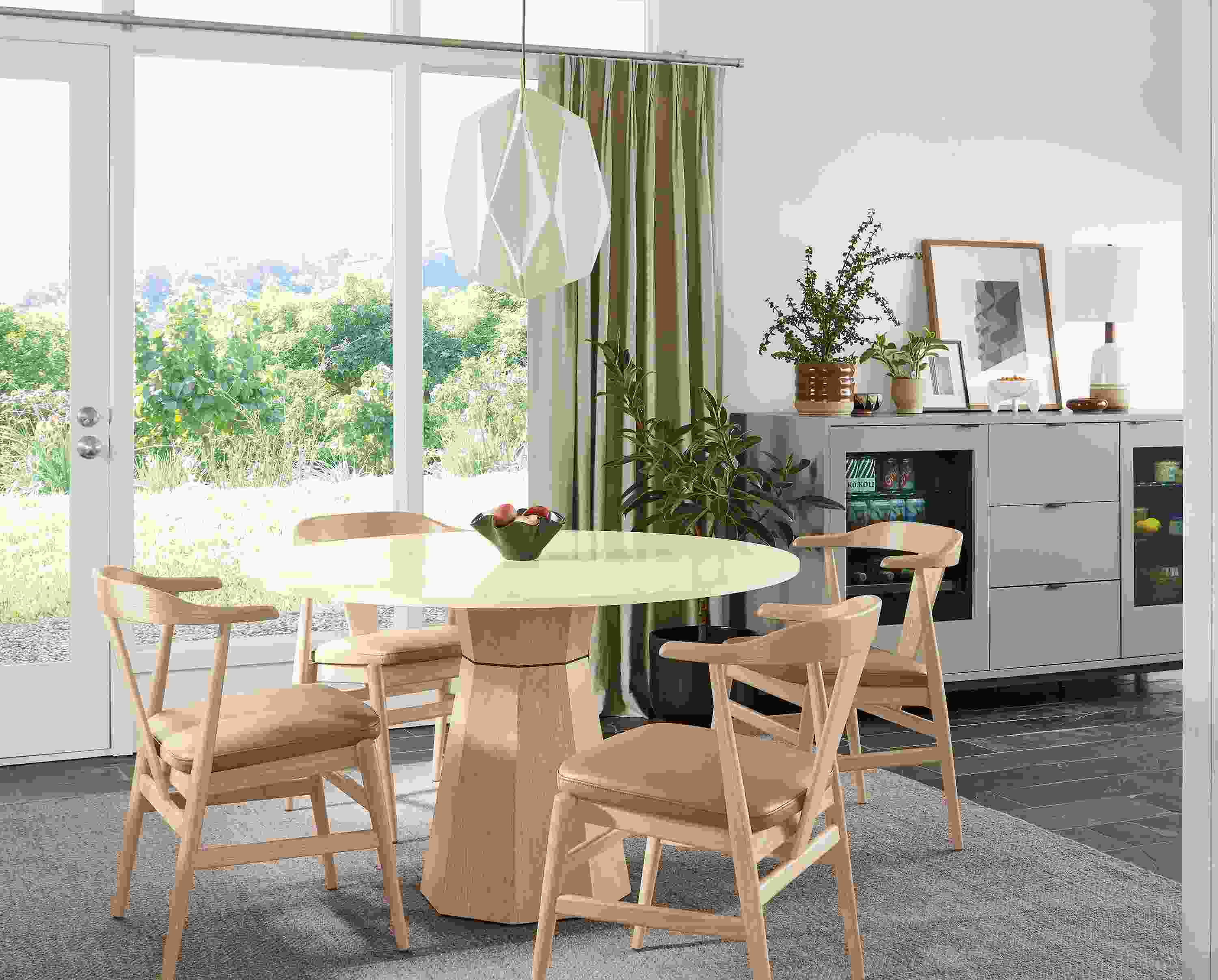 Dining room with a Glover 48 diameter round table in white oak, evan arm chairs in white oak with Pesaro Camel leather seats.