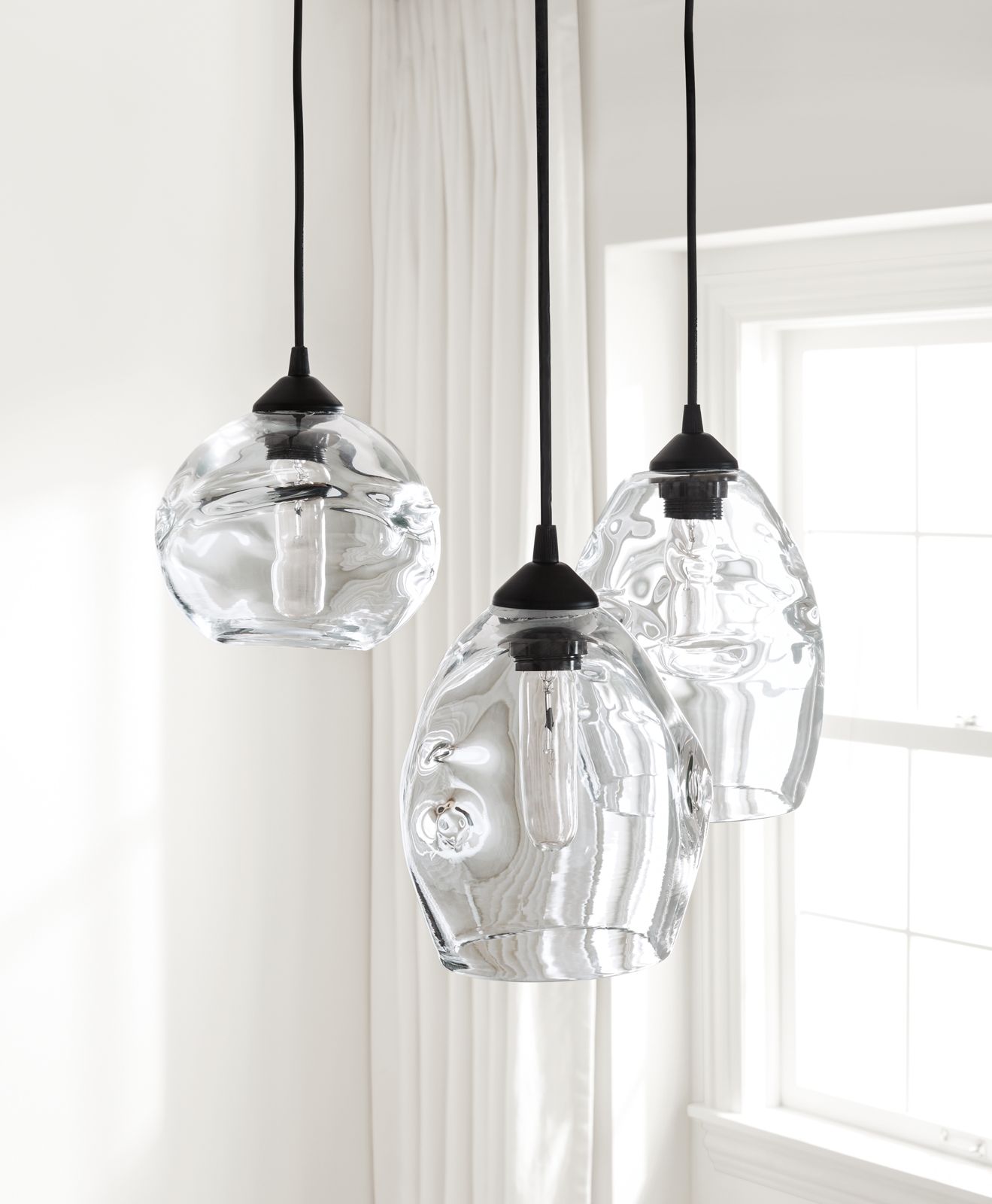 Set of three glass pendant lights.