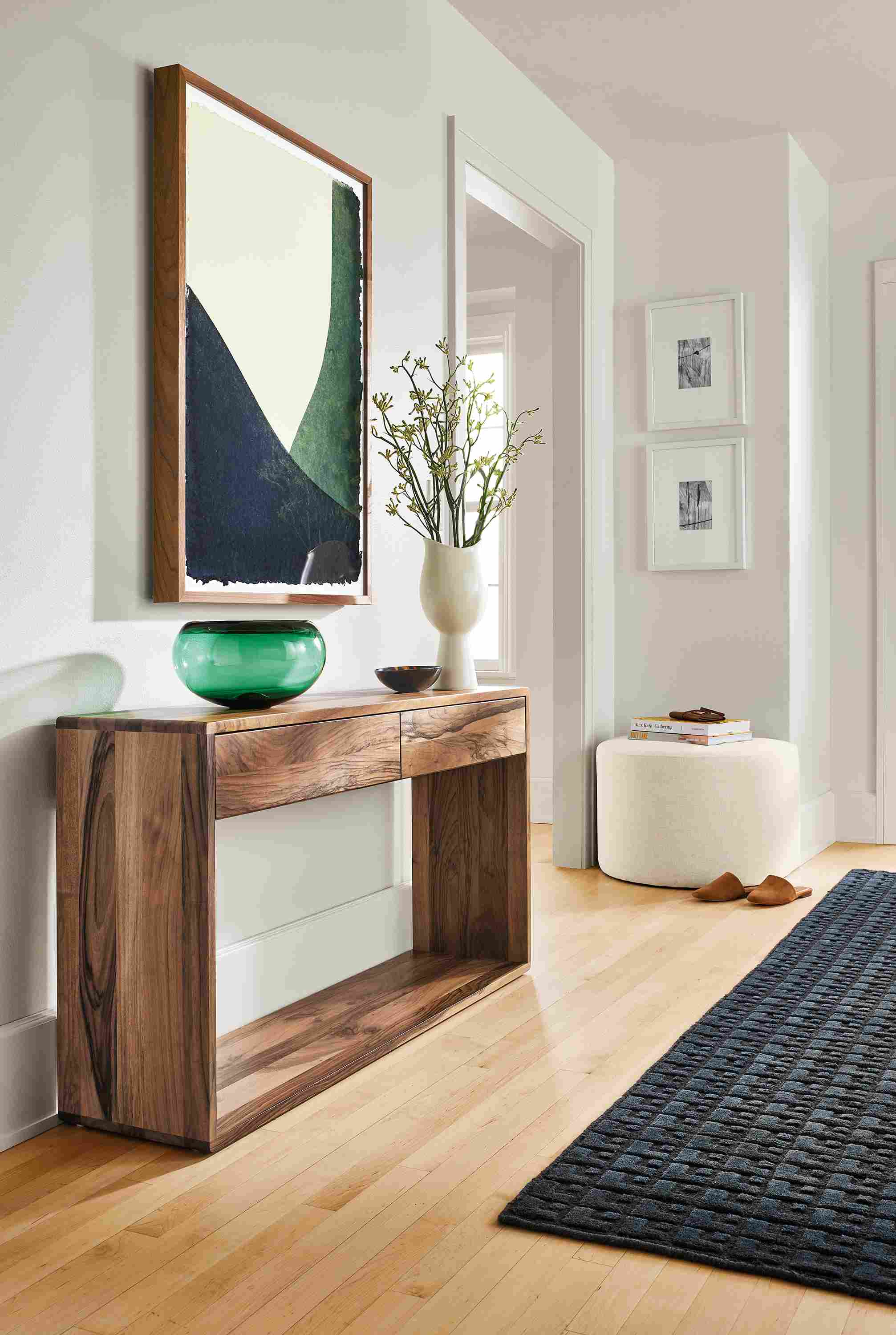 Entryway with Graft console table in walnut, John Robshaw dip dye, Silva ottoman.