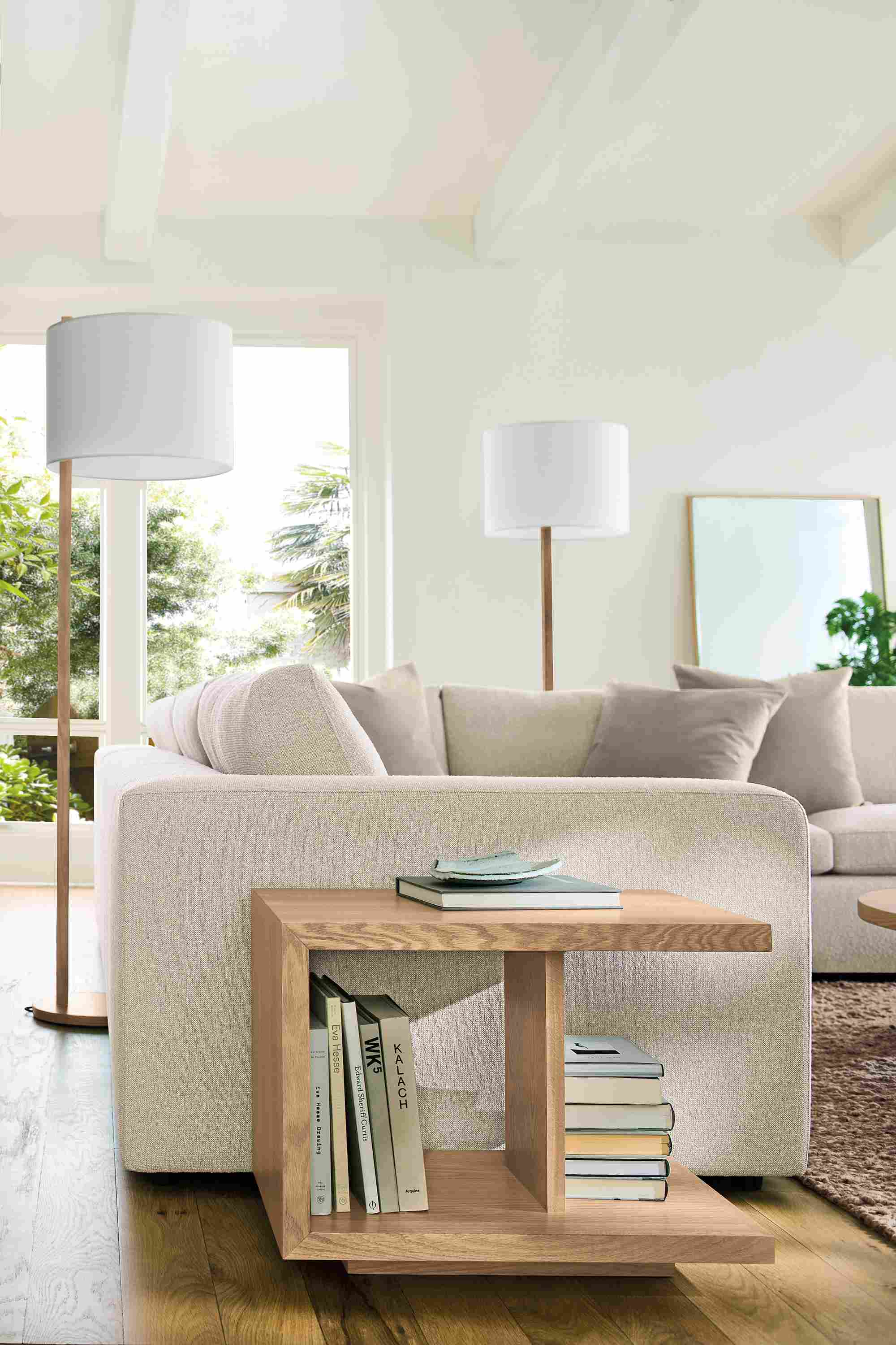 Living room with Graham end table in rye on red oak, Baylor sectional sofa in Conley Natural and Cobble rug in putty.