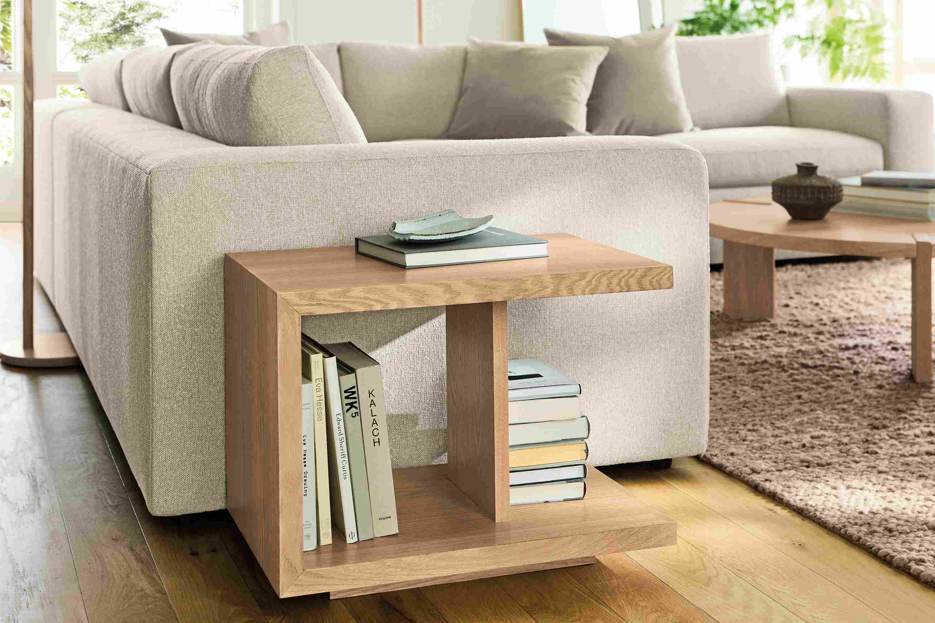 Living room with graham end table in rye on red oak, Baylor sectional sofa in Conley Natural and Cobble rug in putty.