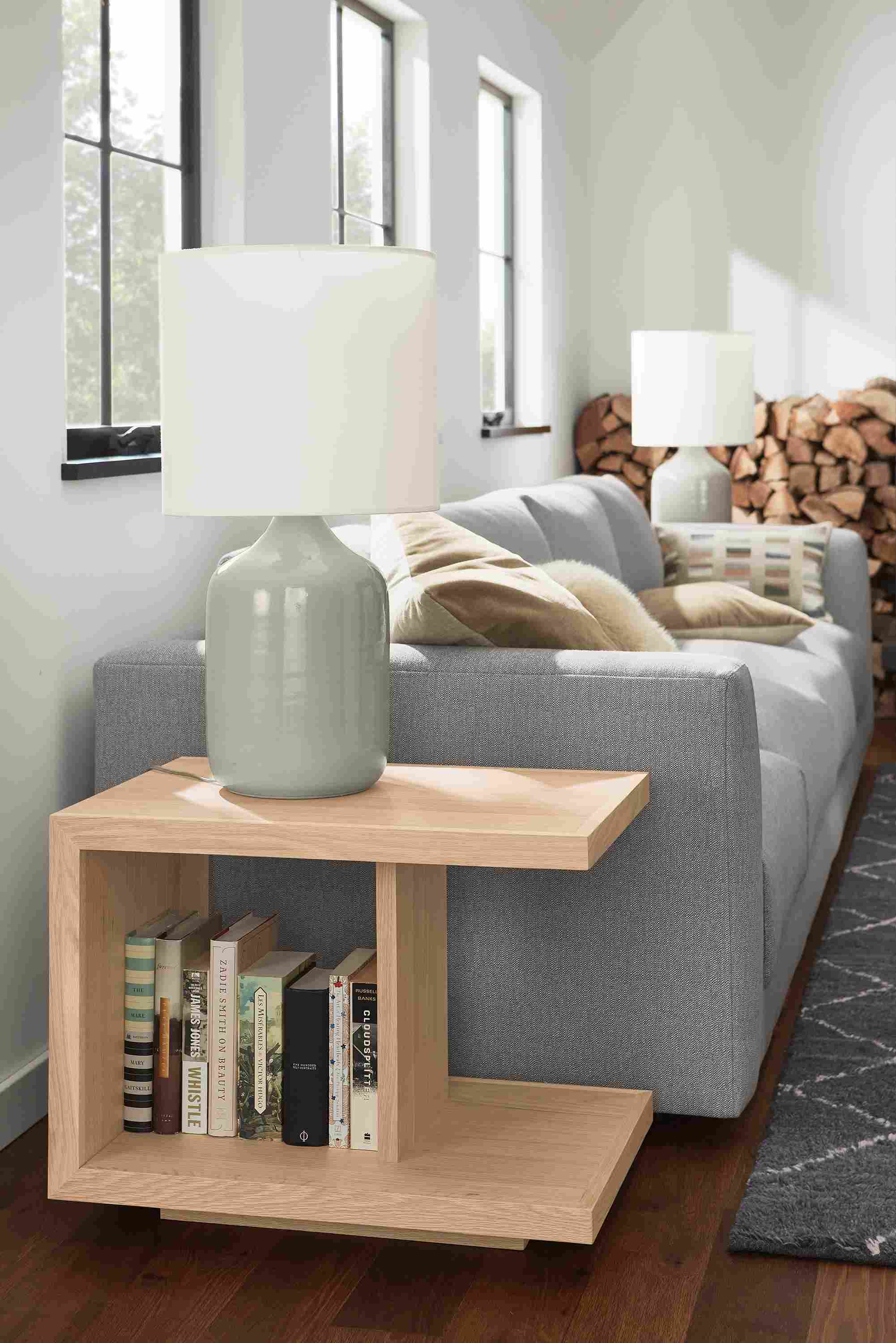 Living room with Graham end table in salt on red oak, Serena table lamp in grey and Clemens sofa in Hines Graphite.