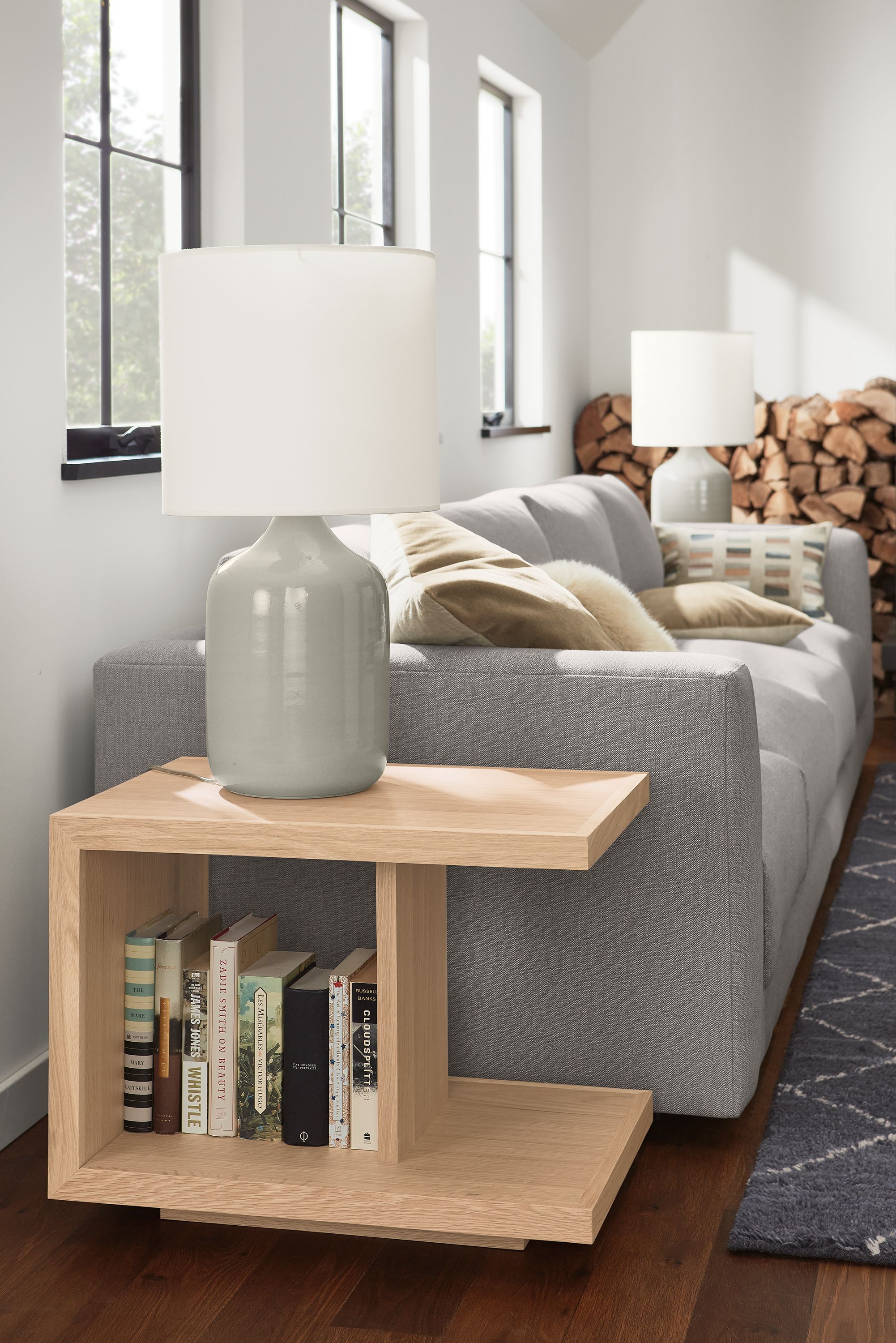 Living room with Graham end table in salt on red oak, Serena table lamp in grey and Clemens sofa in Hines Graphite.