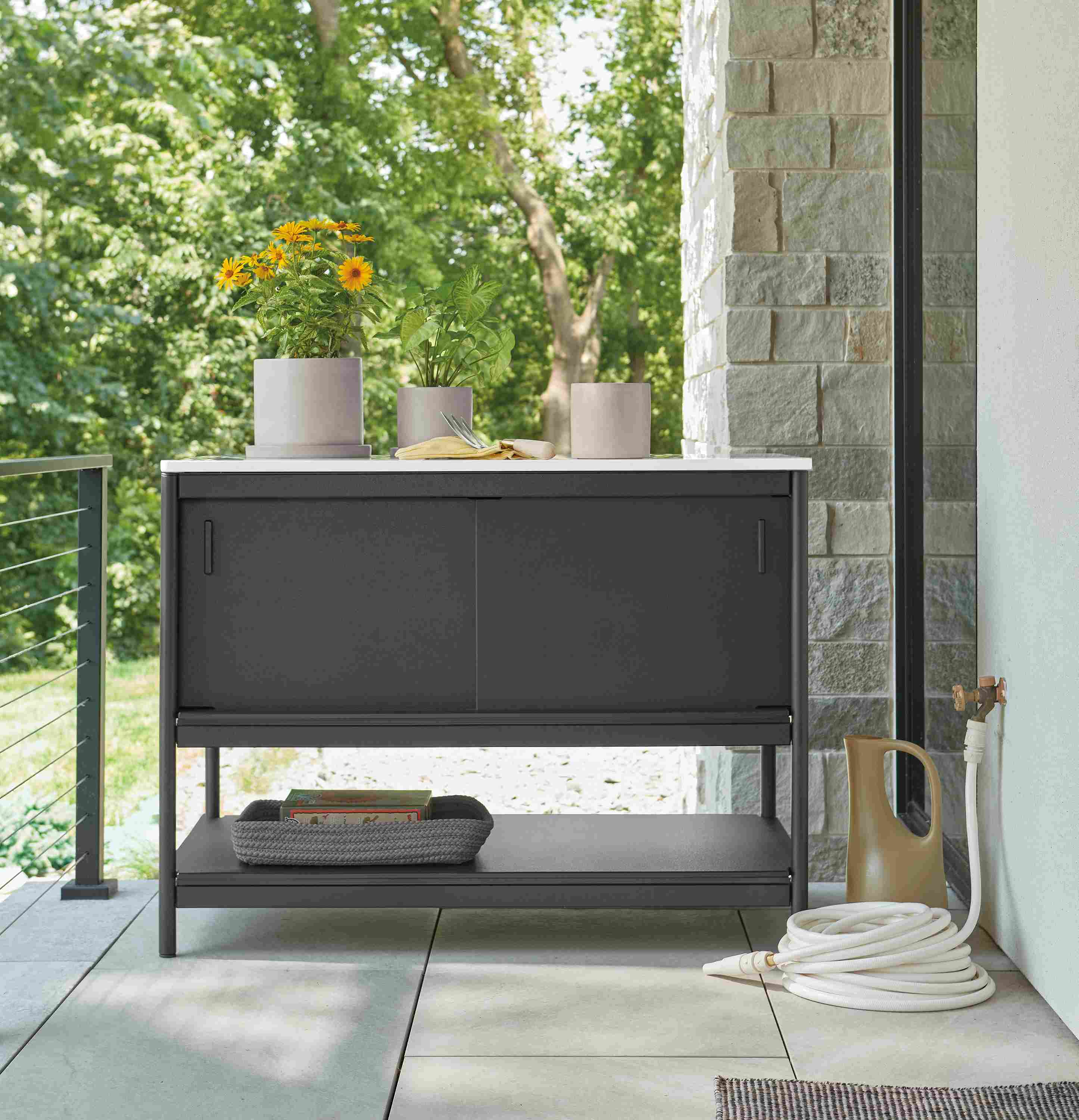 Granger outdoor kitchen half-storage cabinet in black HDPE with marbled white quartz top.
