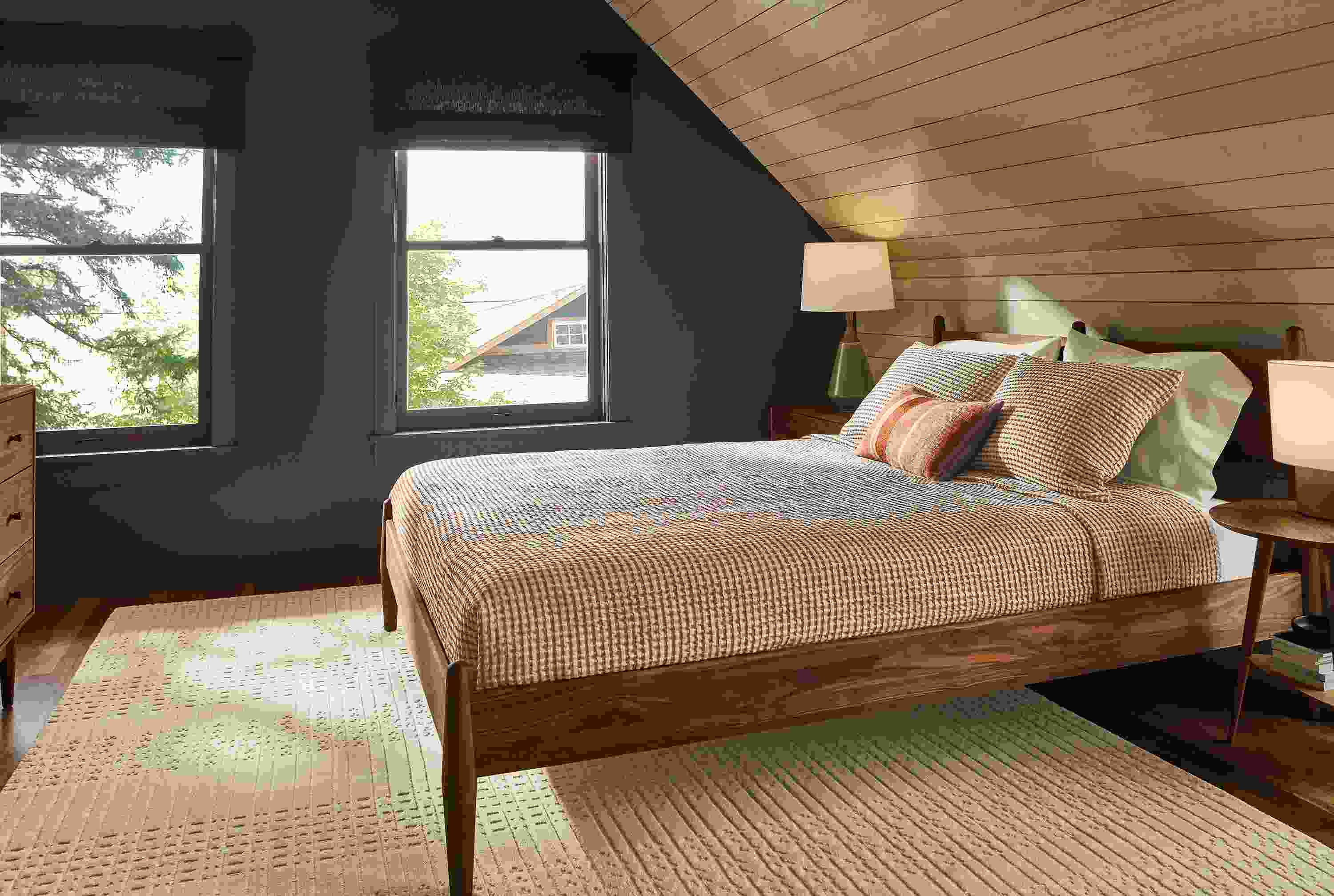 Bedroom with Grove queen bed, dresser and nightstand in walnut, Bria rug in ivory and Westin coverlet in brick.