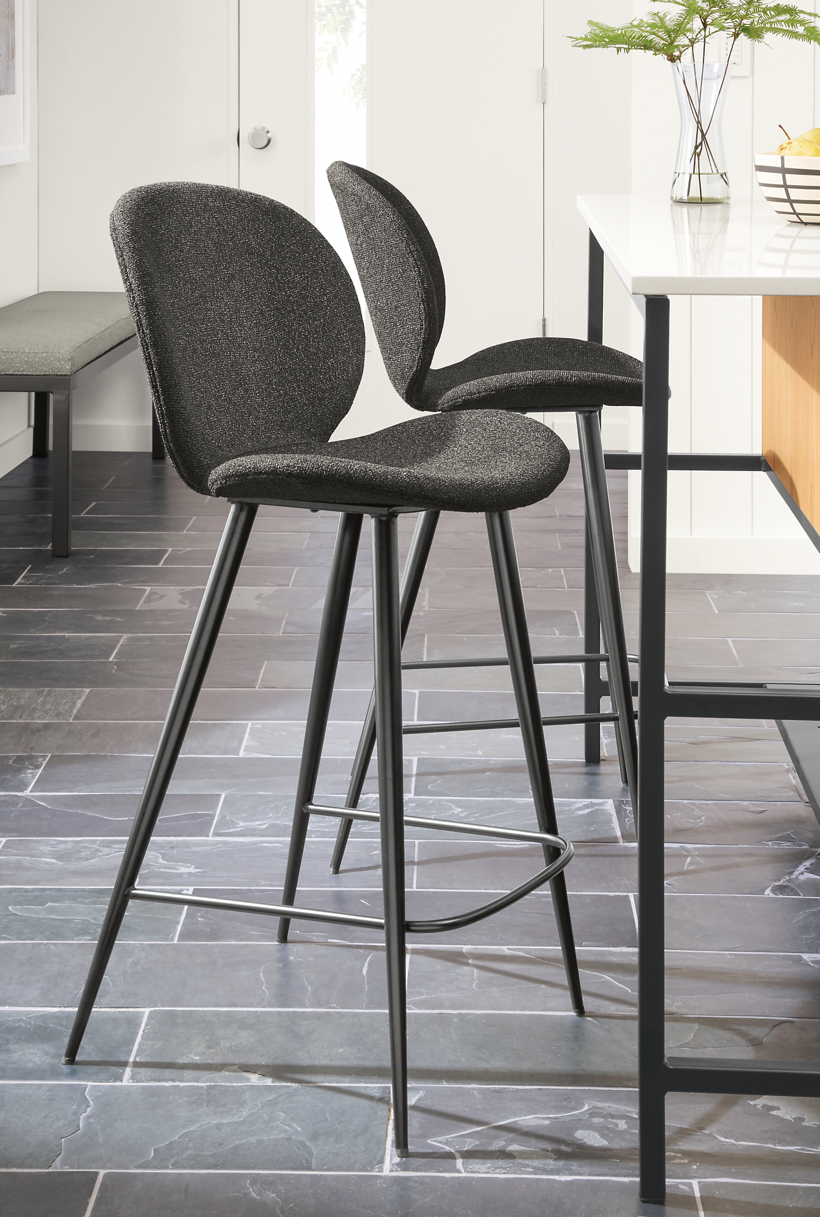 Detail of 2 Gwen counter stools in Radford Grey fabric set at Booker kitchen island.