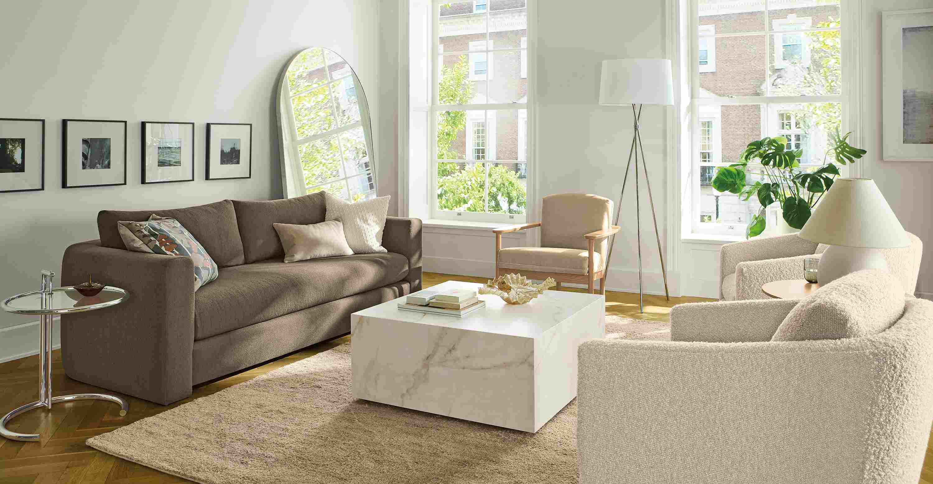 Living room with Hannah 86-wide sofa in Dusk Mink, 2 Ford swivel chairs in Dornick Ivory and Kalindi rug in flax.