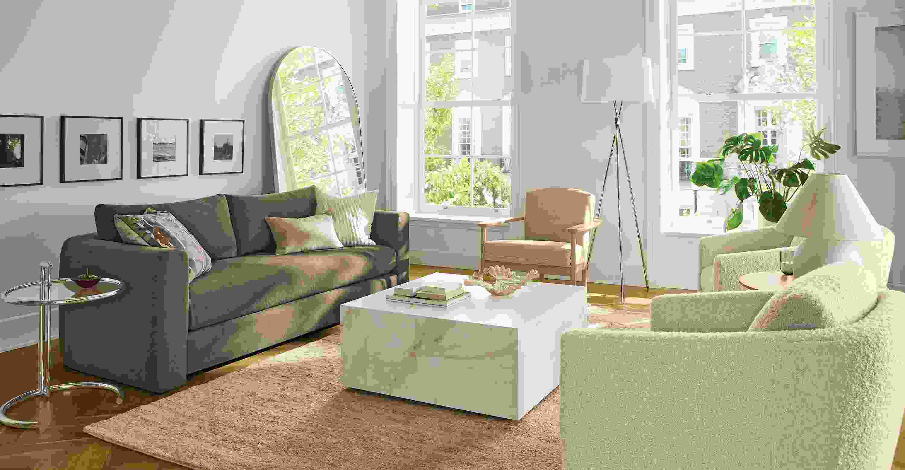 Living room with Hannah 86-wide sofa in Dusk Mink, 2 Ford swivel chairs in Dornick Ivory and Kalindi rug in flax.