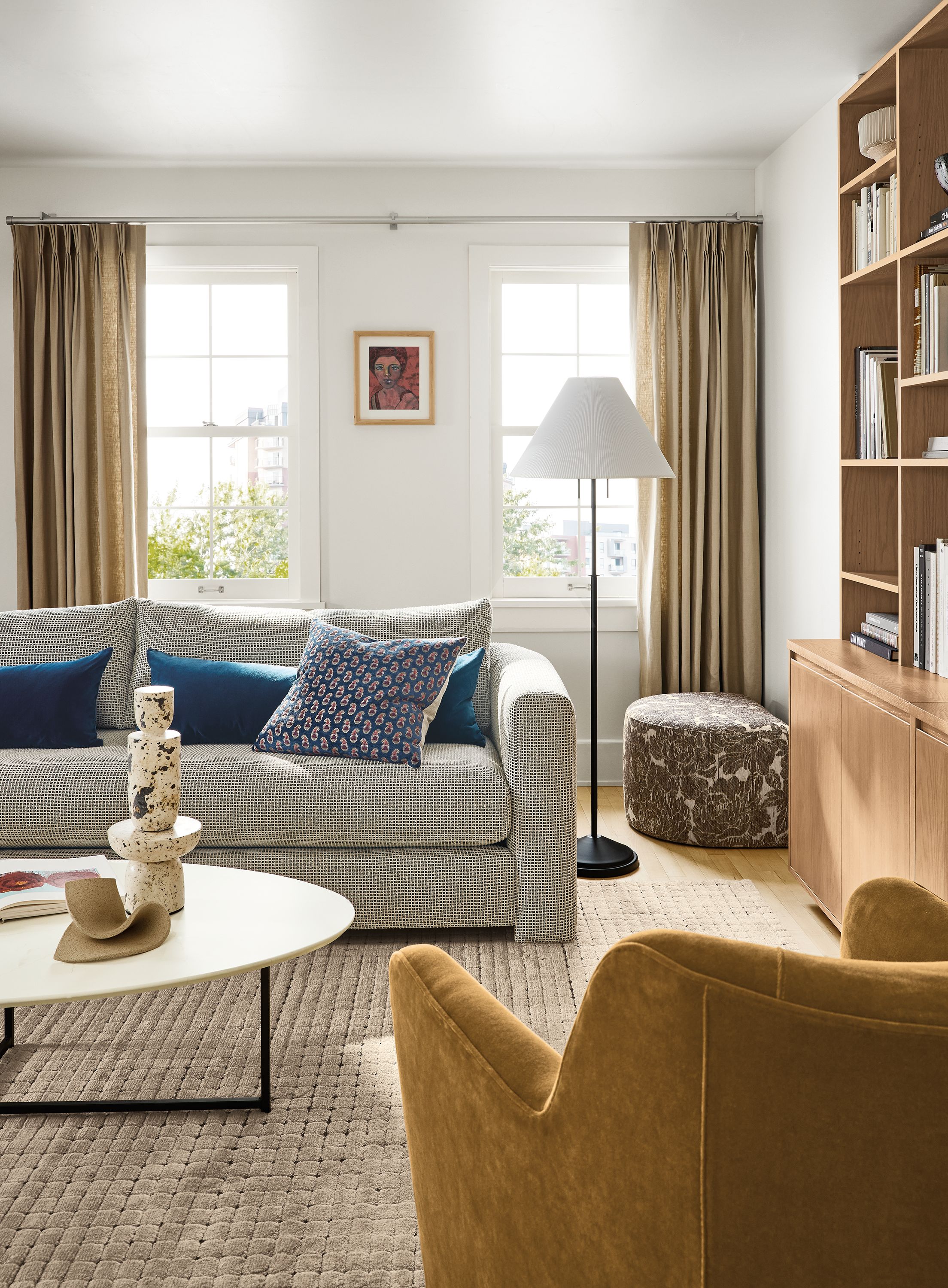 Living room with Hannah sofa in Dorsa Mink, Lily chair in Redding Bronze and Safira rug in Ecru.