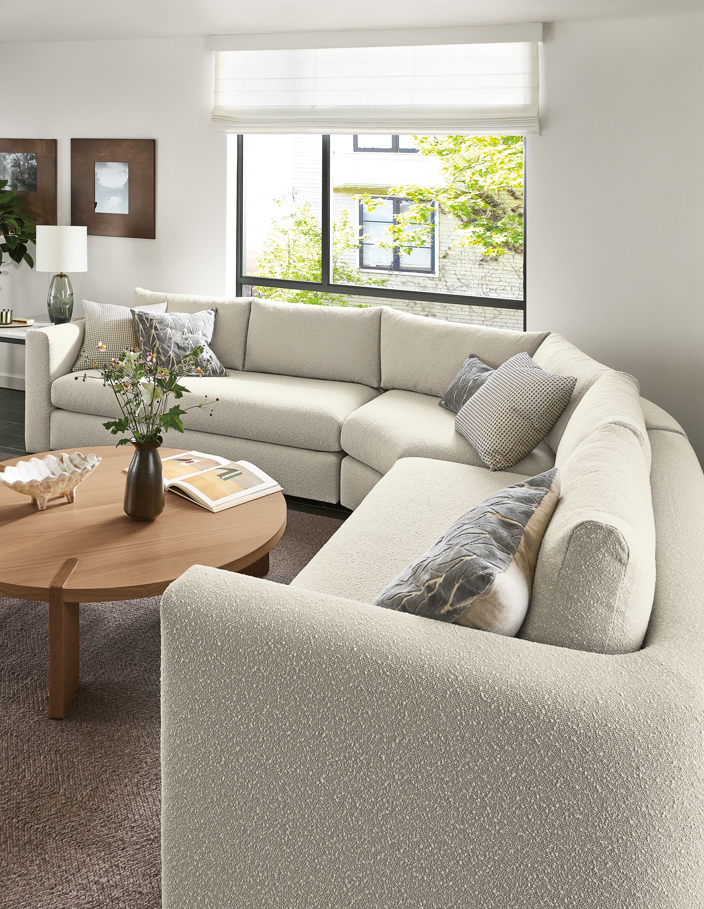 Living room detail of hannah 124 by 124 three-piece sectional in declan natural and Hanover coffee table in rye on red oak.