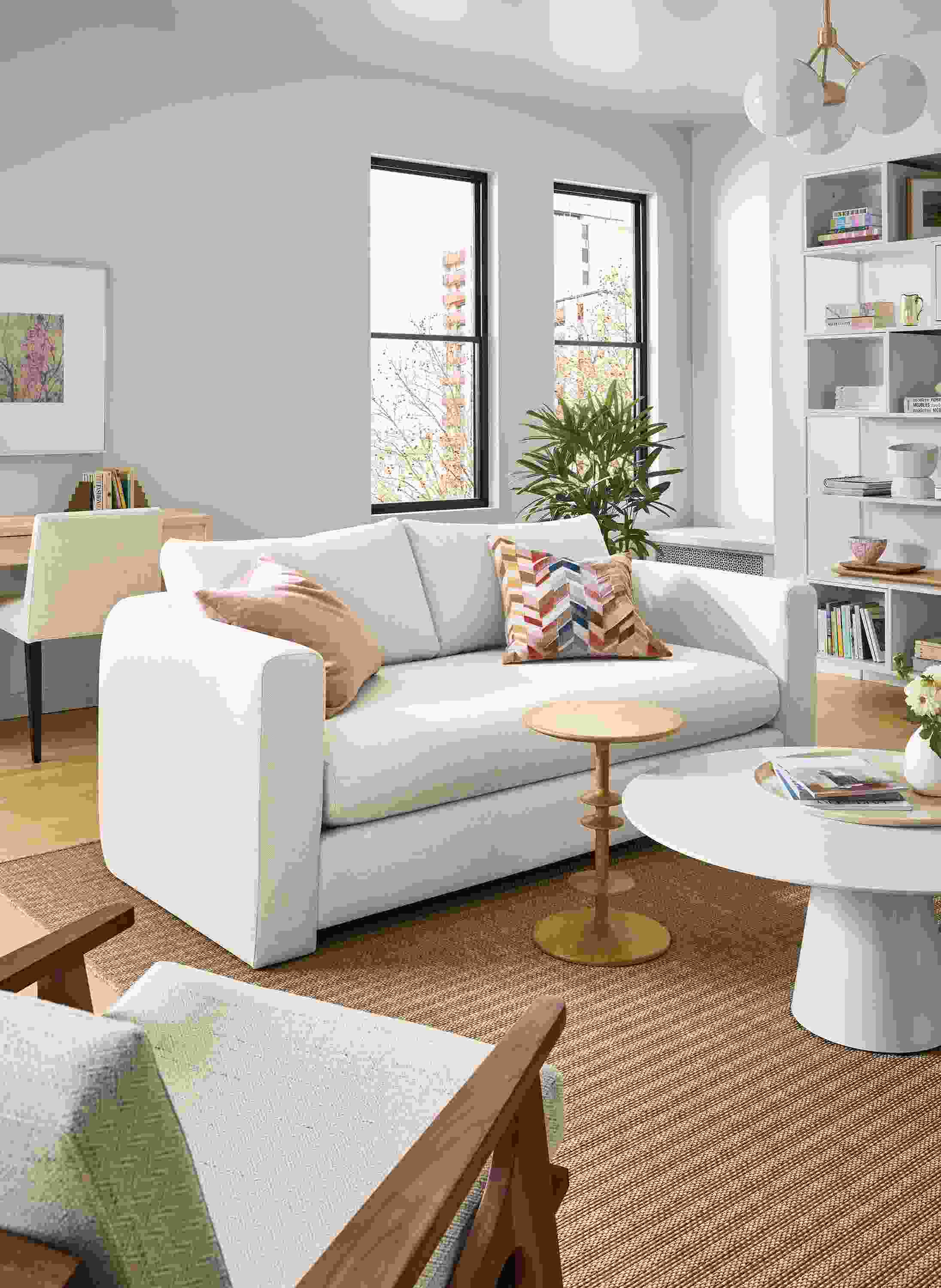 Living room with Hannah 76-wide bench cushion sofa in sumner ivory, Decker coffee table in white and Parks end table in white oak.