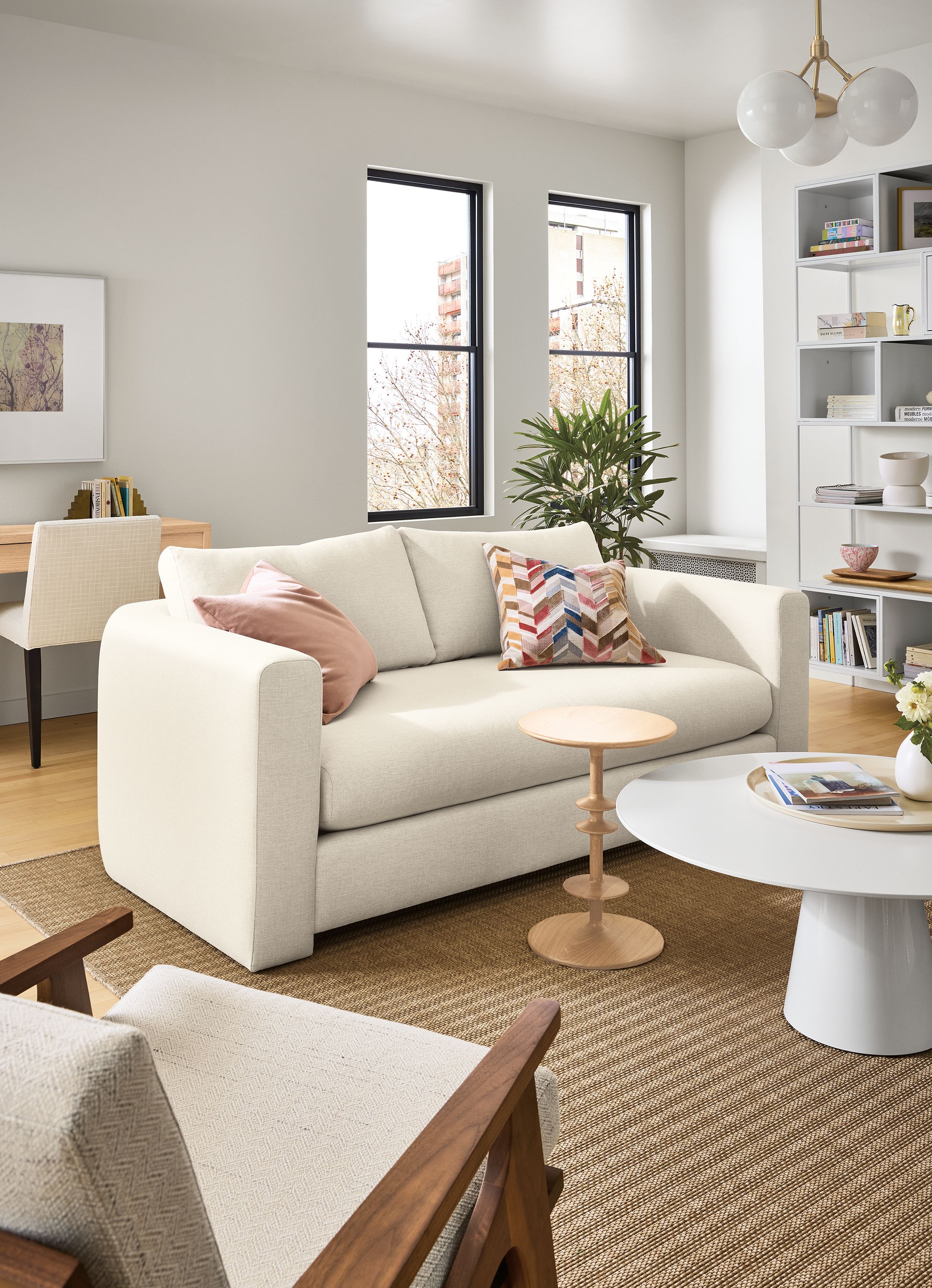 Living room with Hannah 76-wide bench cushion sofa in sumner ivory, decker coffee table in white and parks end table in white oak.