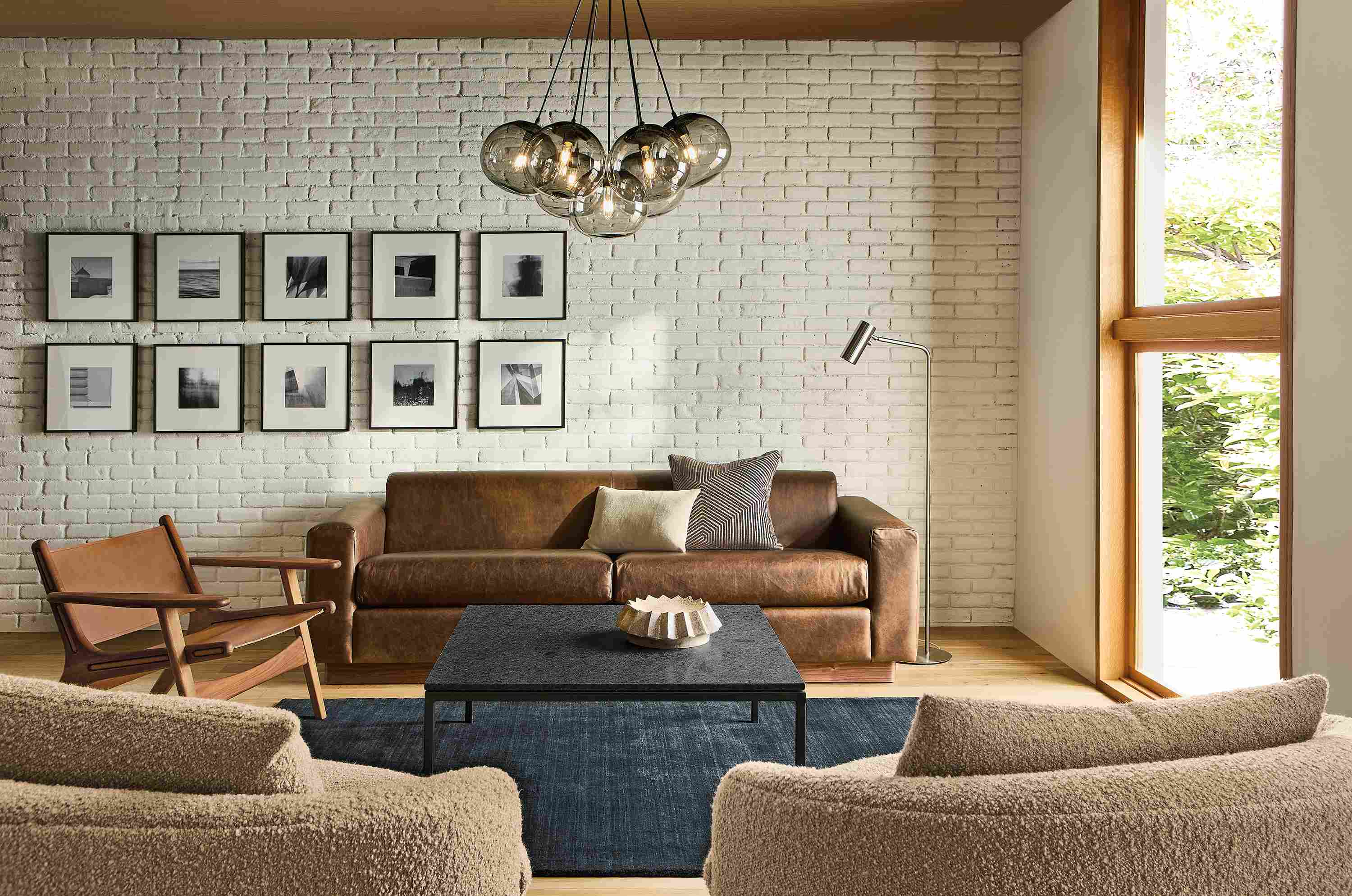 Living room with Harmon 95-wide sofa in Palermo Bourbon leather and Parsons table in Mesabi Black granite and natural steel.