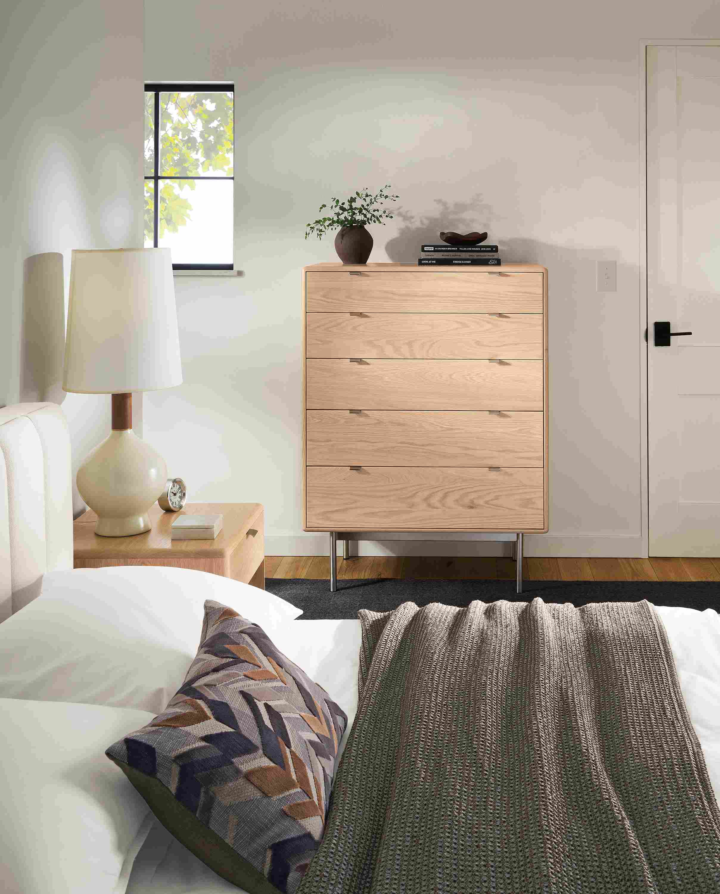Bedroom with Hensley 36-wide 5-drawer dresser in salt on red oak and Hartley queen storage bed in Landen white.