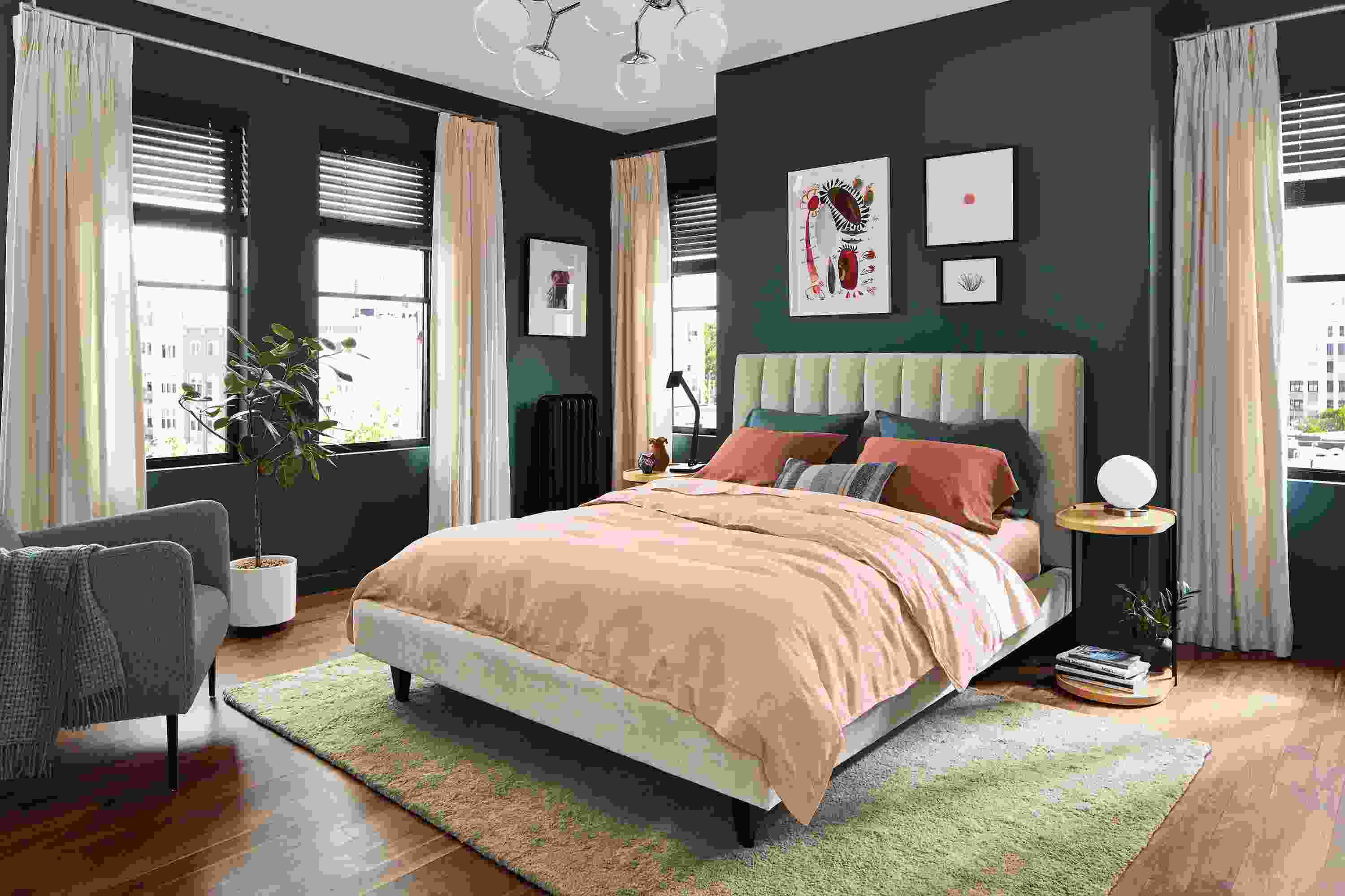 bedroom setting with hartley bed in mori oatmeal fabric with colorful bedding.