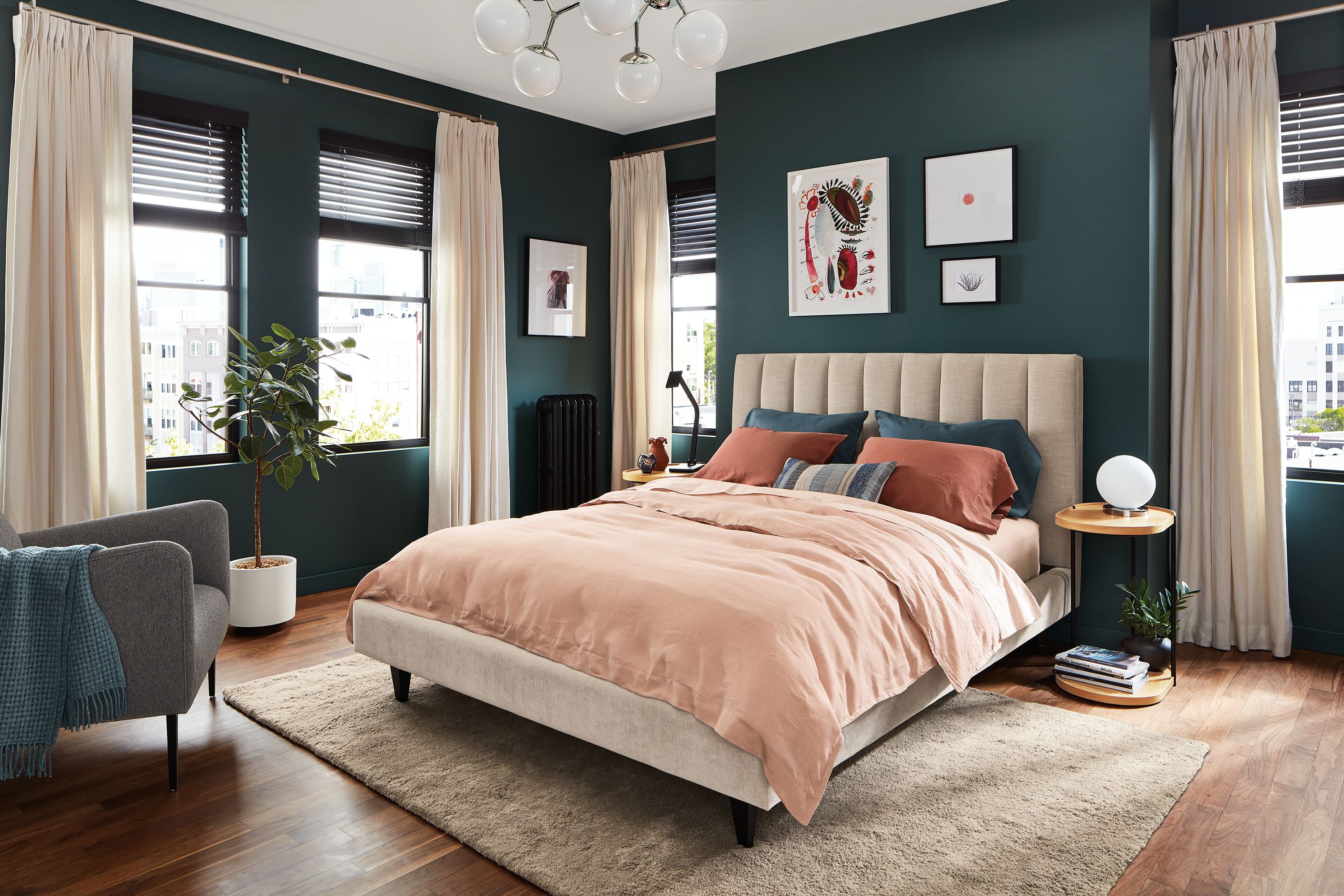 bedroom setting with hartley bed in mori oatmeal fabric with colorful bedding.