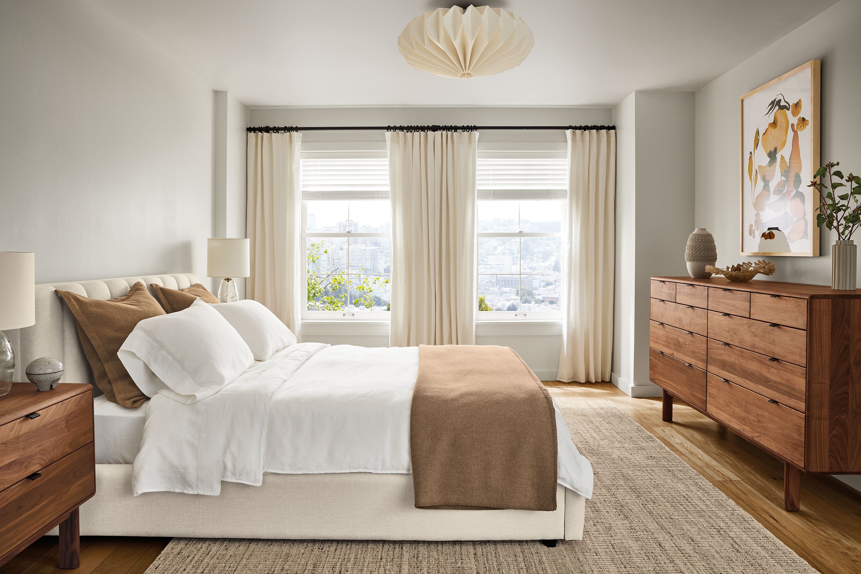 Bedroom with Hartley queen bed in sumner ivory, Hensley nightstand in walnut and Artis 8 by 10 rug in stone.