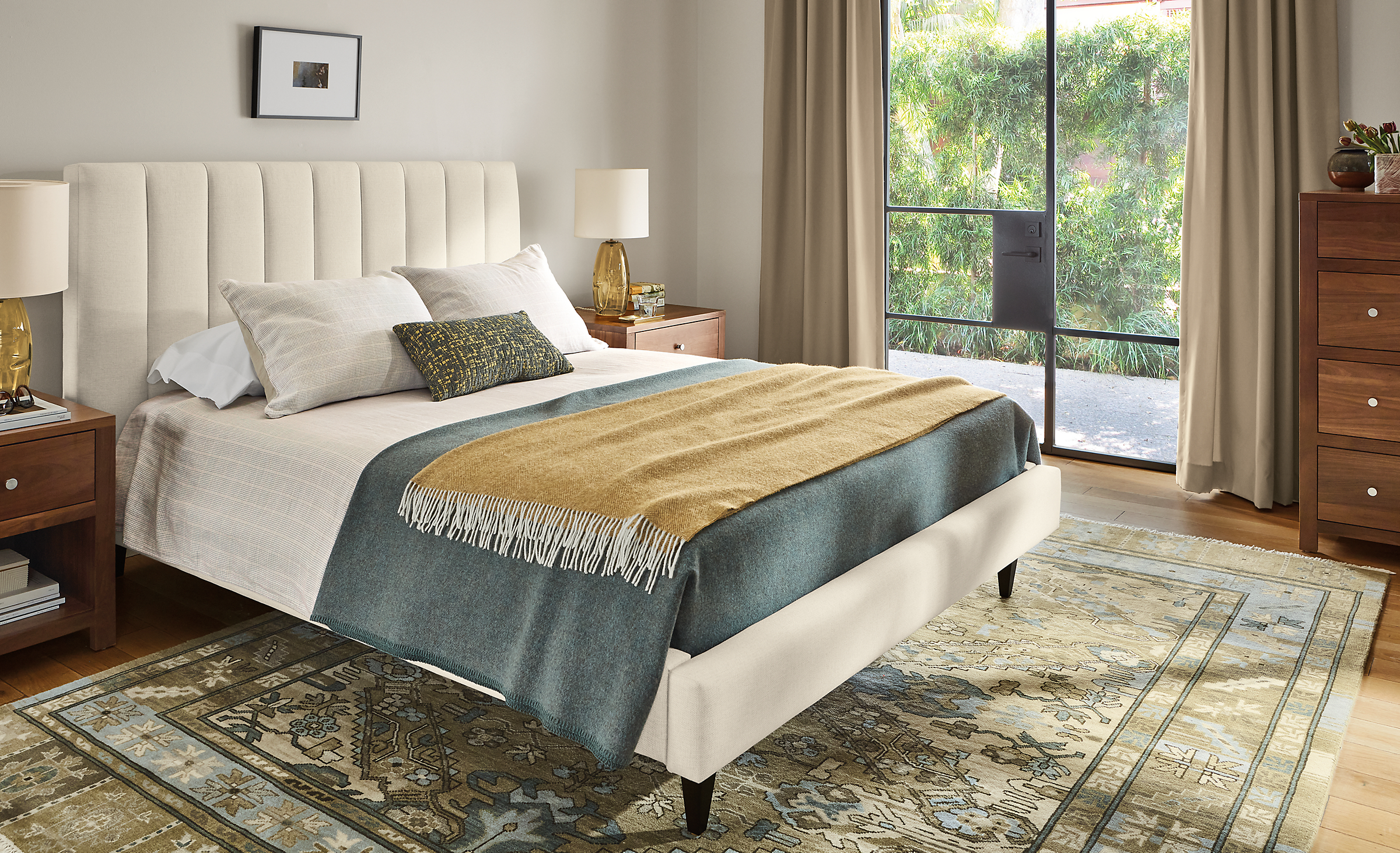 Bedroom with Hartley queen bed in Sumner ivory, Kayseri rug in moss, Corwin dresser and nightstands in walnut.
