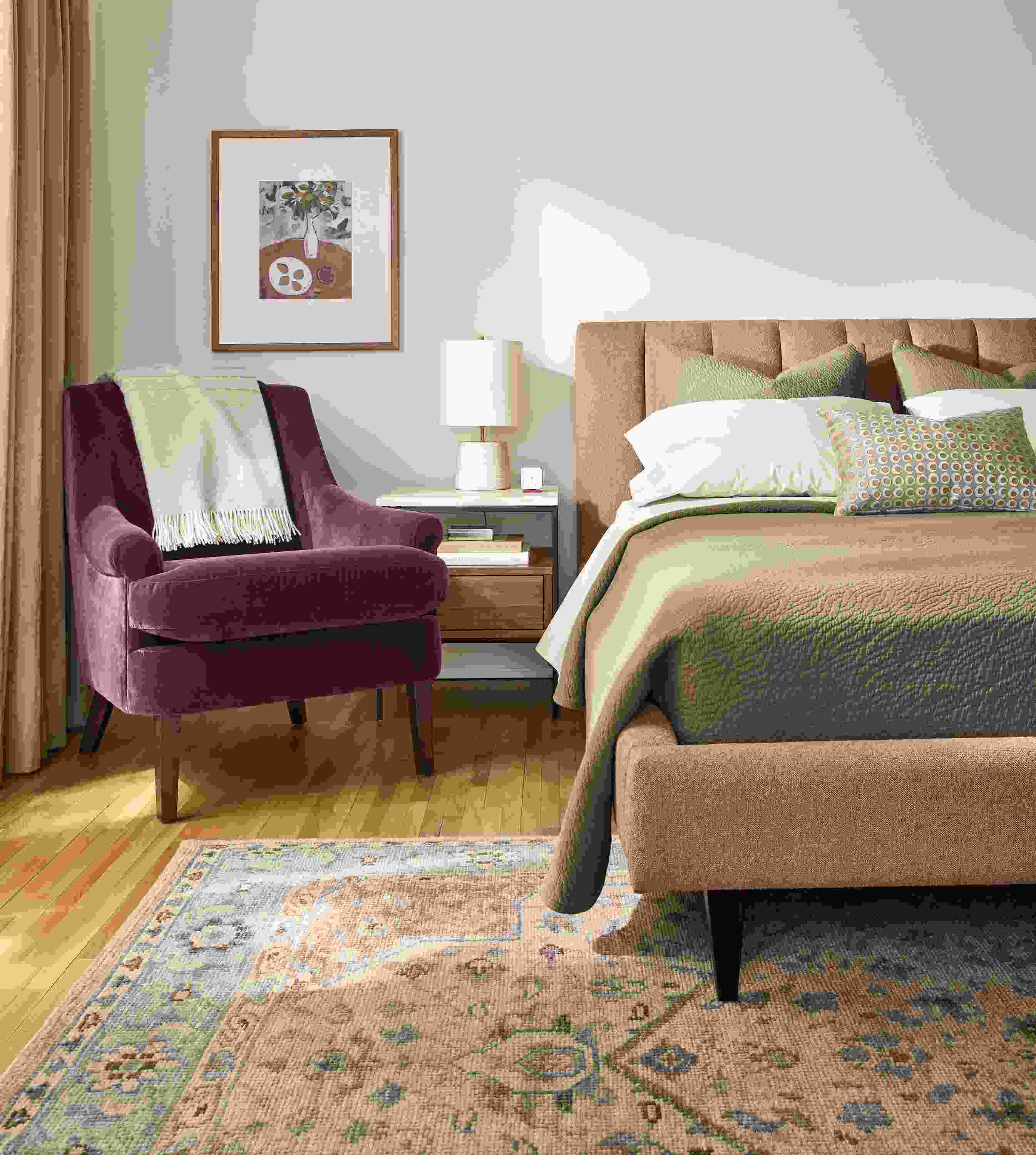 Bedroom with Hartley Queen bed in Declan Sienna, Louise Chair in Redding Plum and Veda 6 by 9 rug in Camel.