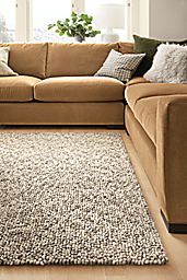Detail of Hastings rug in Ivory/Taupe in living room with Metro sofa in Banks Camel.