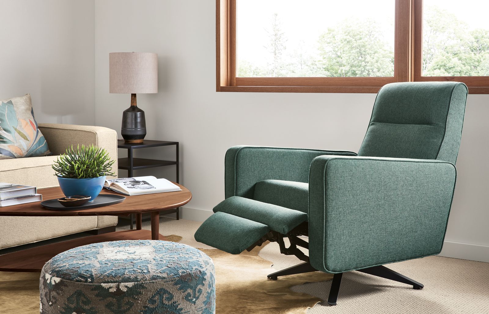 Hayden recliner in turquoise fabric extended in living room.